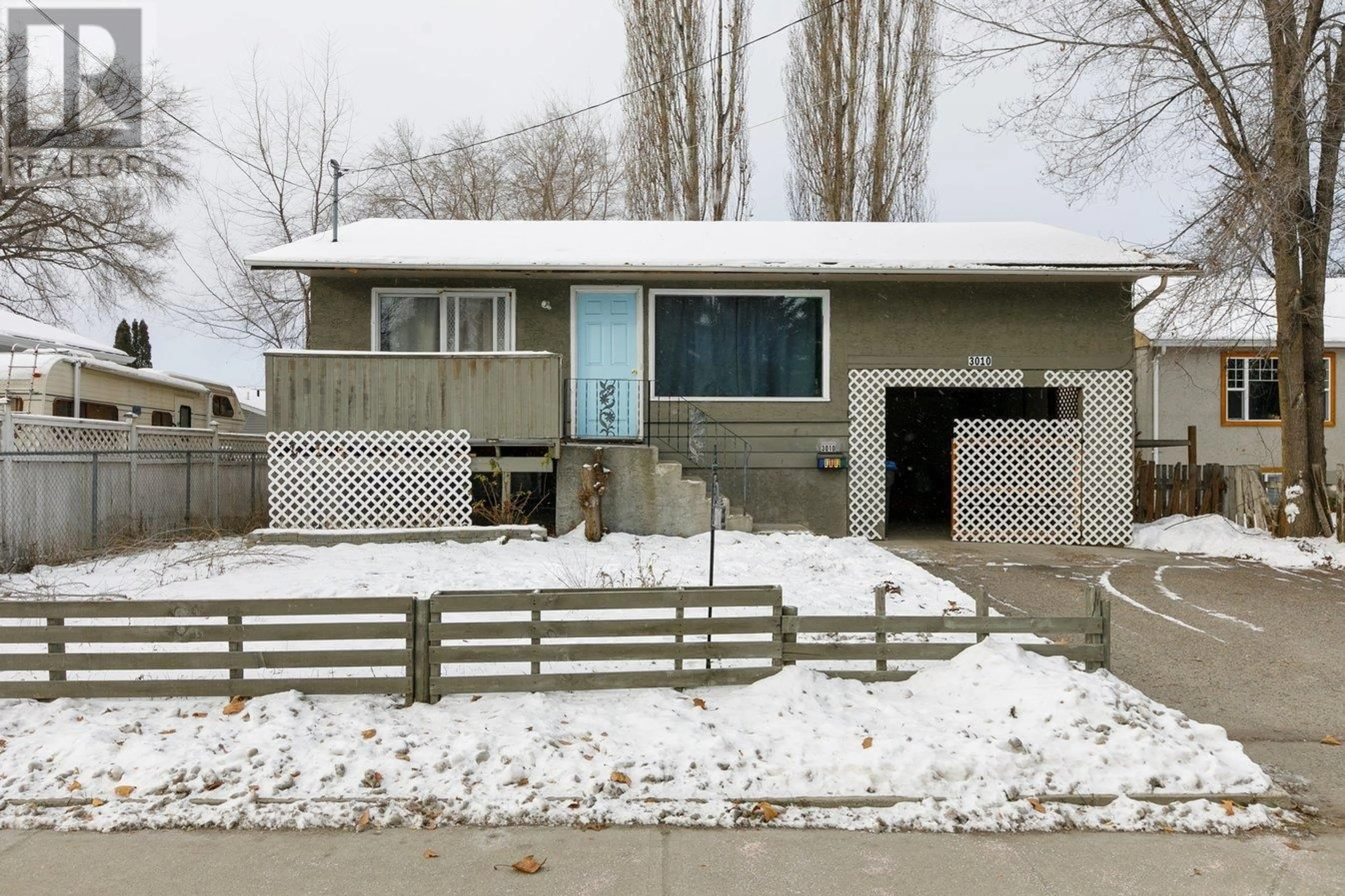 Home with vinyl exterior material, street for 3010 Gordon Drive, Kelowna British Columbia V1V2E2