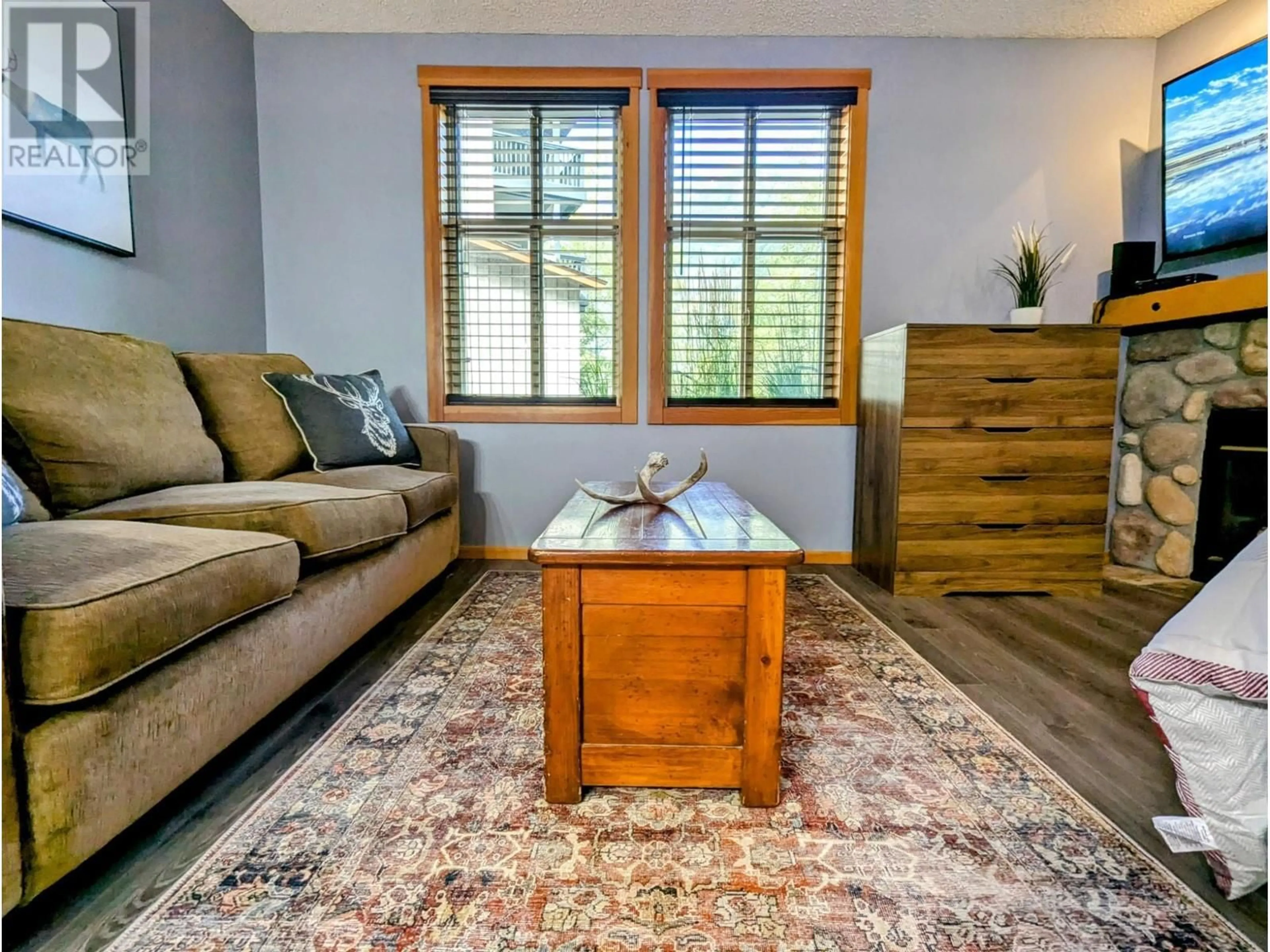 Living room with furniture, wood/laminate floor for 2060 SUMMIT Drive Unit# 104, Panorama British Columbia V0A1T0