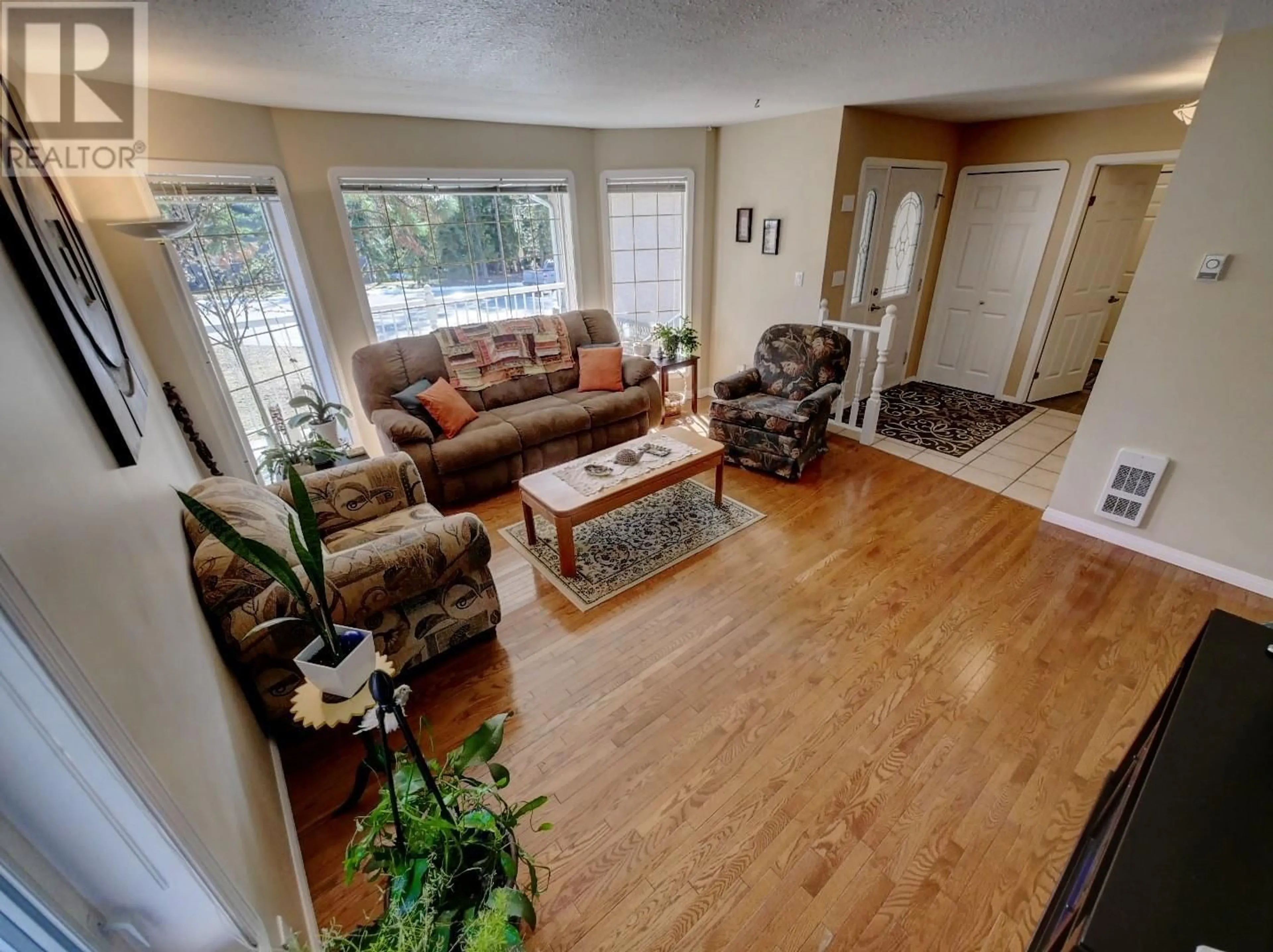 Living room with furniture, wood/laminate floor for 1910 Leaning Tree Road, Lister British Columbia V0B1G2