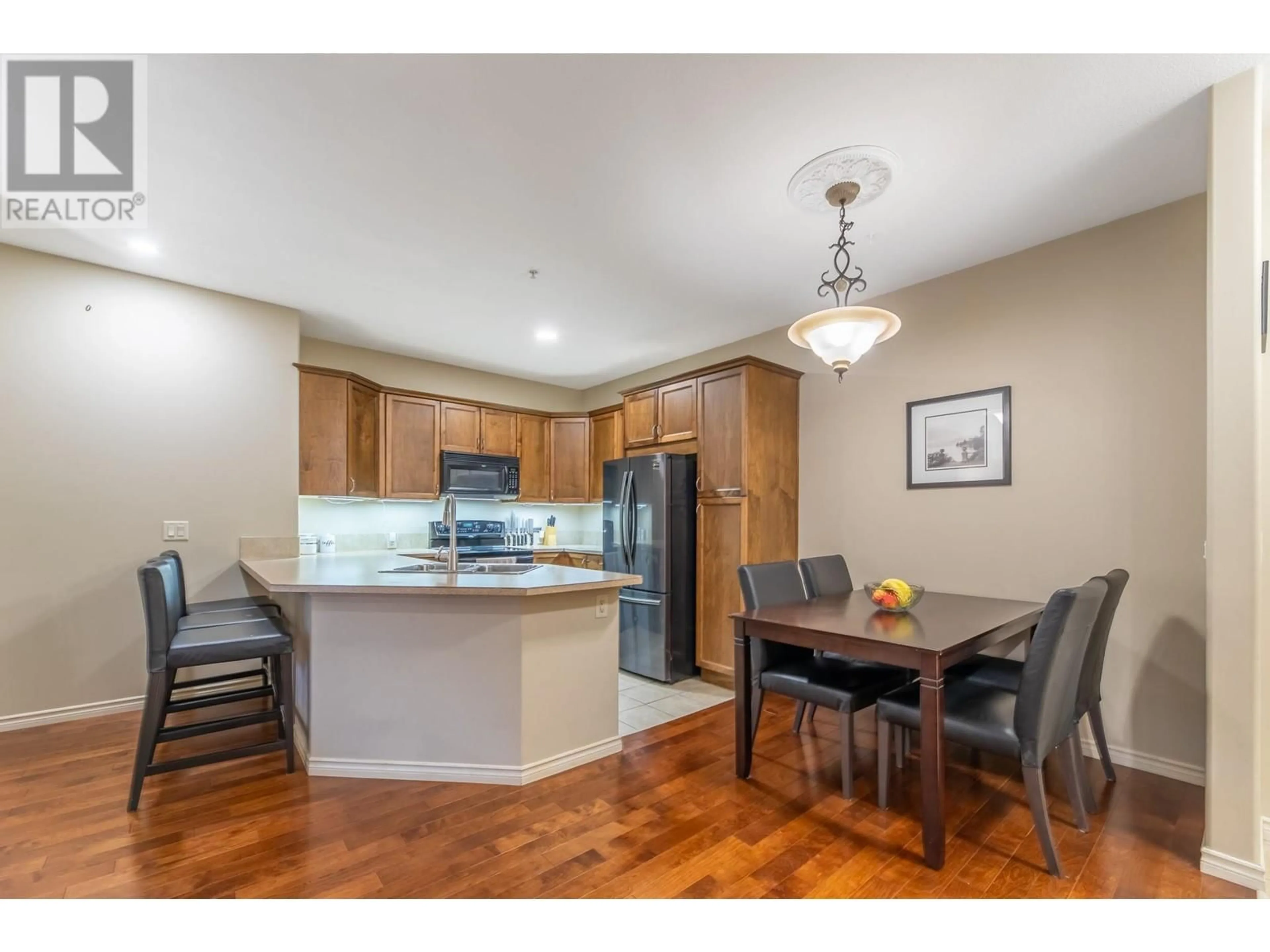 Open concept kitchen, wood/laminate floor for 1007 Harvey Avenue Unit# 206, Kelowna British Columbia V1Y6E4