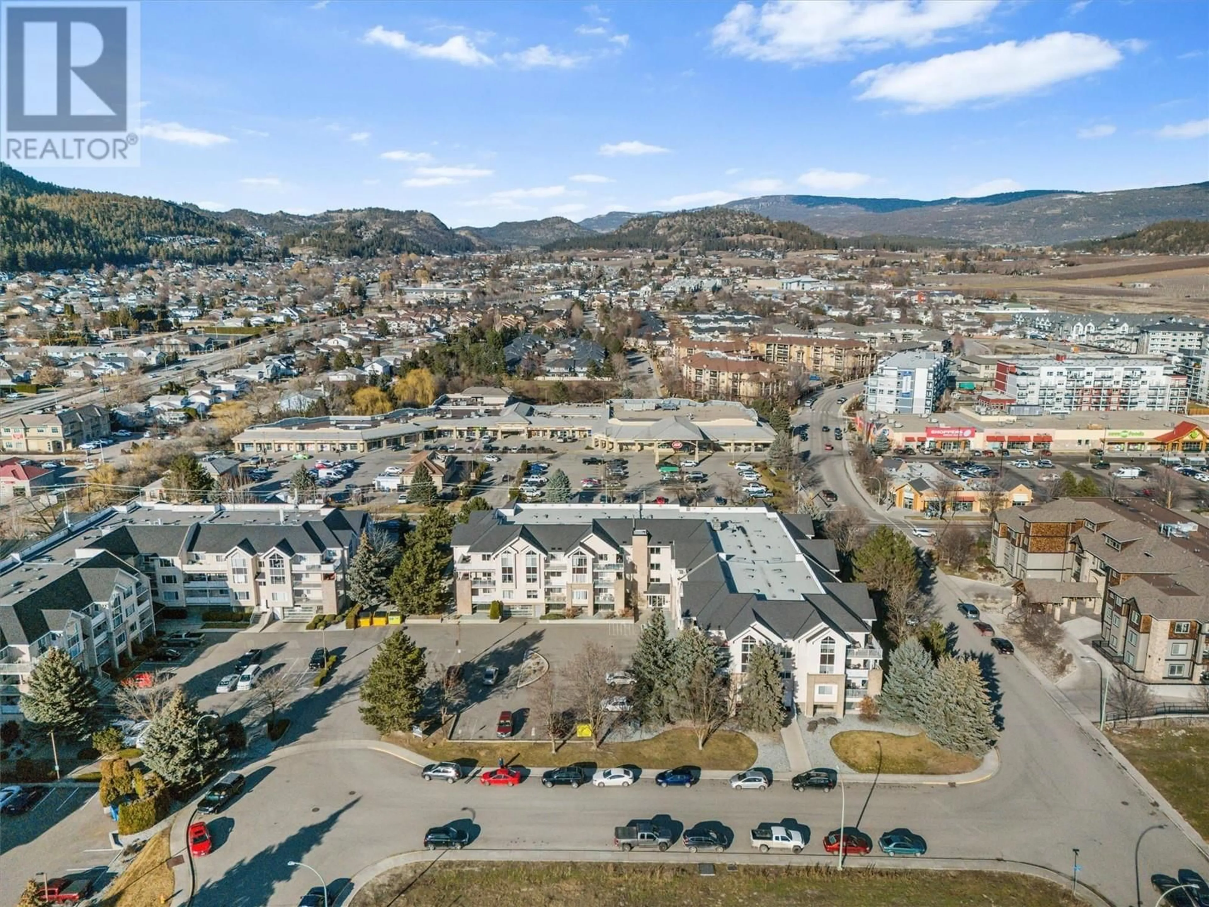 A pic from outside/outdoor area/front of a property/back of a property/a pic from drone, mountain view for 400 Sutton Crescent Unit# 205, Kelowna British Columbia V1V2A5