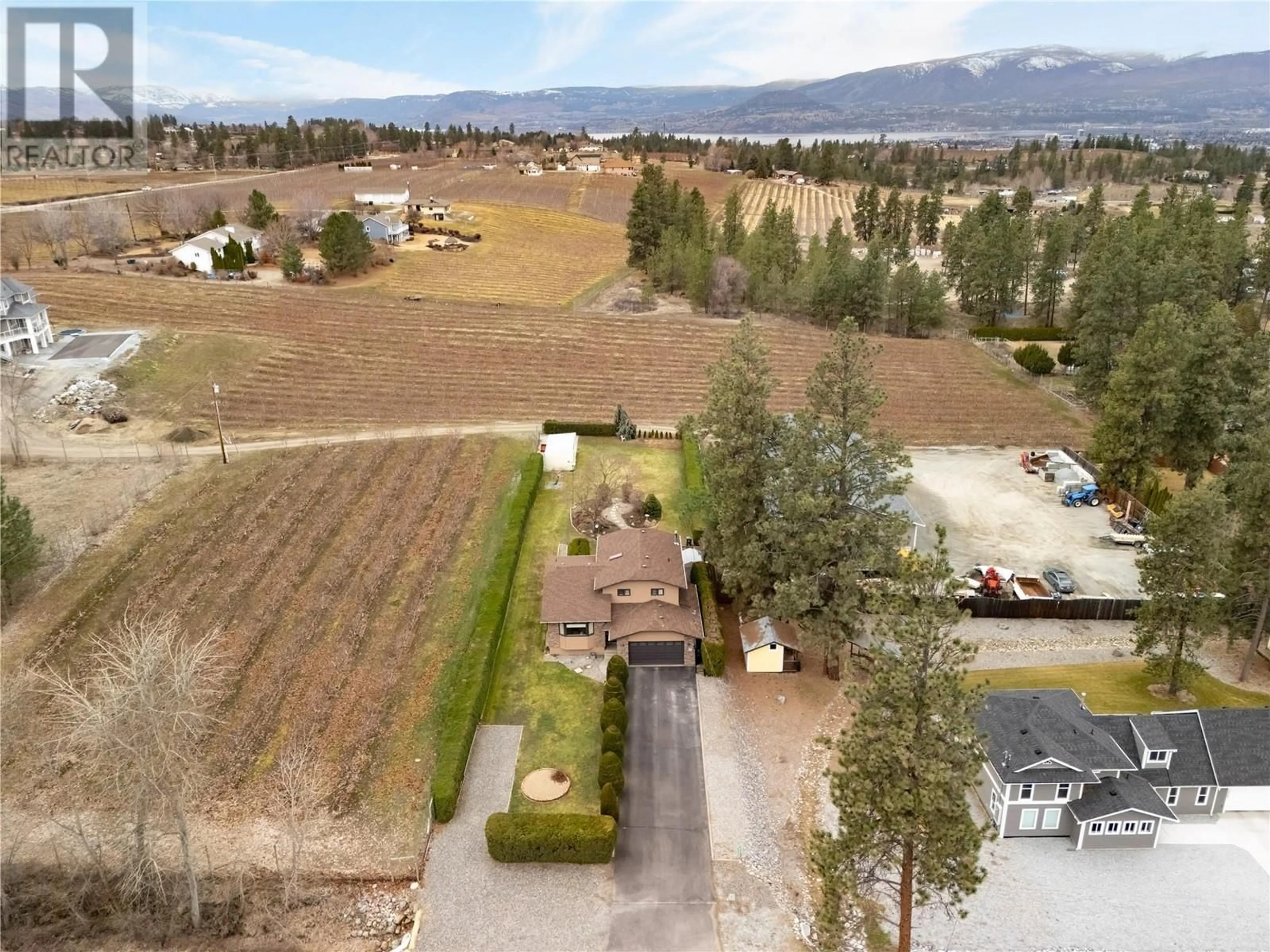 A pic from outside/outdoor area/front of a property/back of a property/a pic from drone, mountain view for 3970 June Springs Road, Kelowna British Columbia V1W4E4