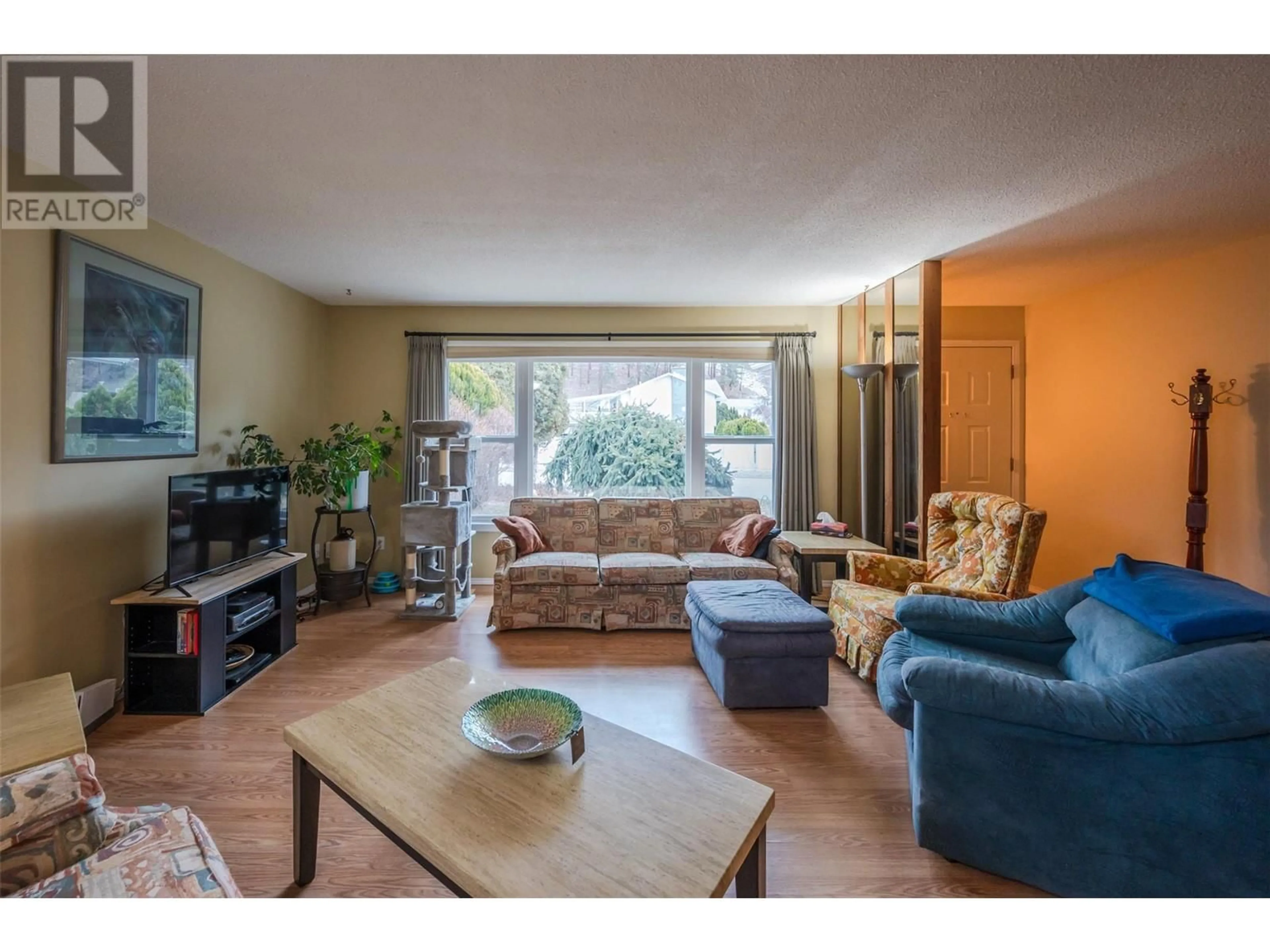 Living room with furniture, wood/laminate floor for 1725 Duncan Avenue E, Penticton British Columbia V2A7C3