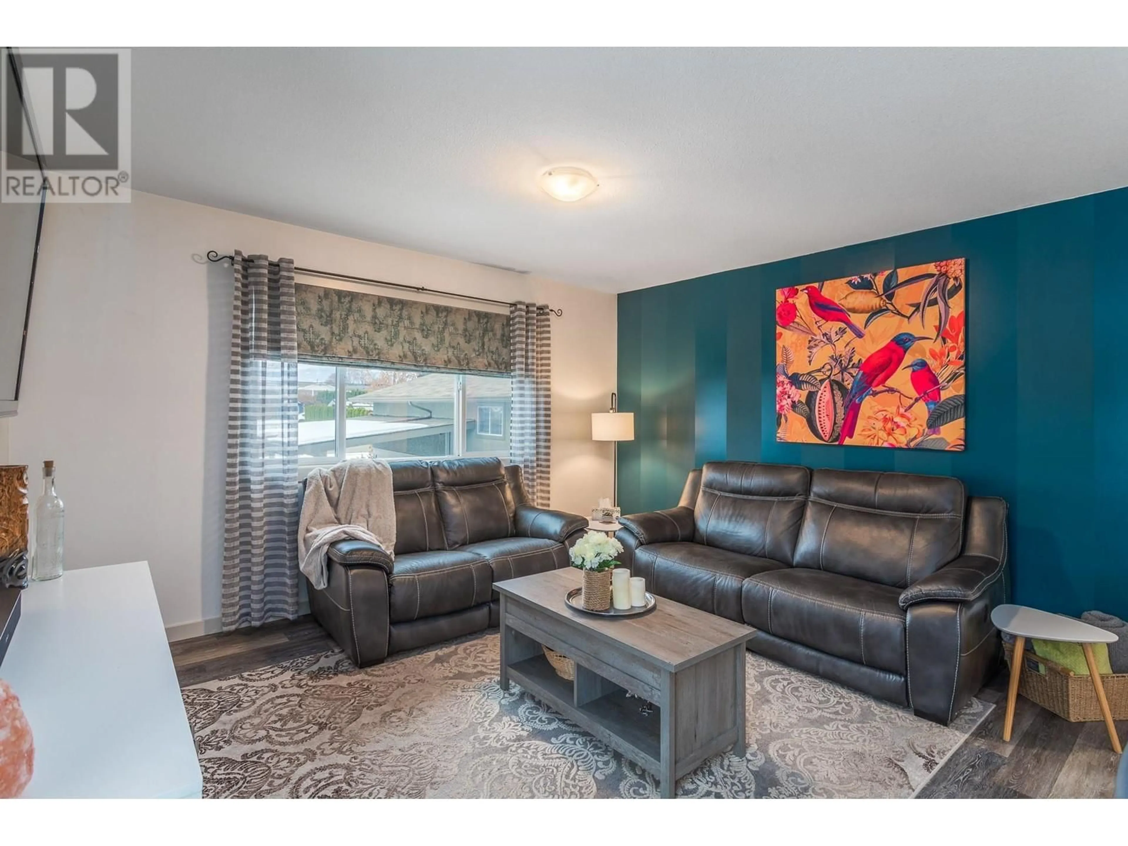 Living room with furniture, wood/laminate floor for 384 HARDIE ROAD, Kelowna British Columbia V1X2H2