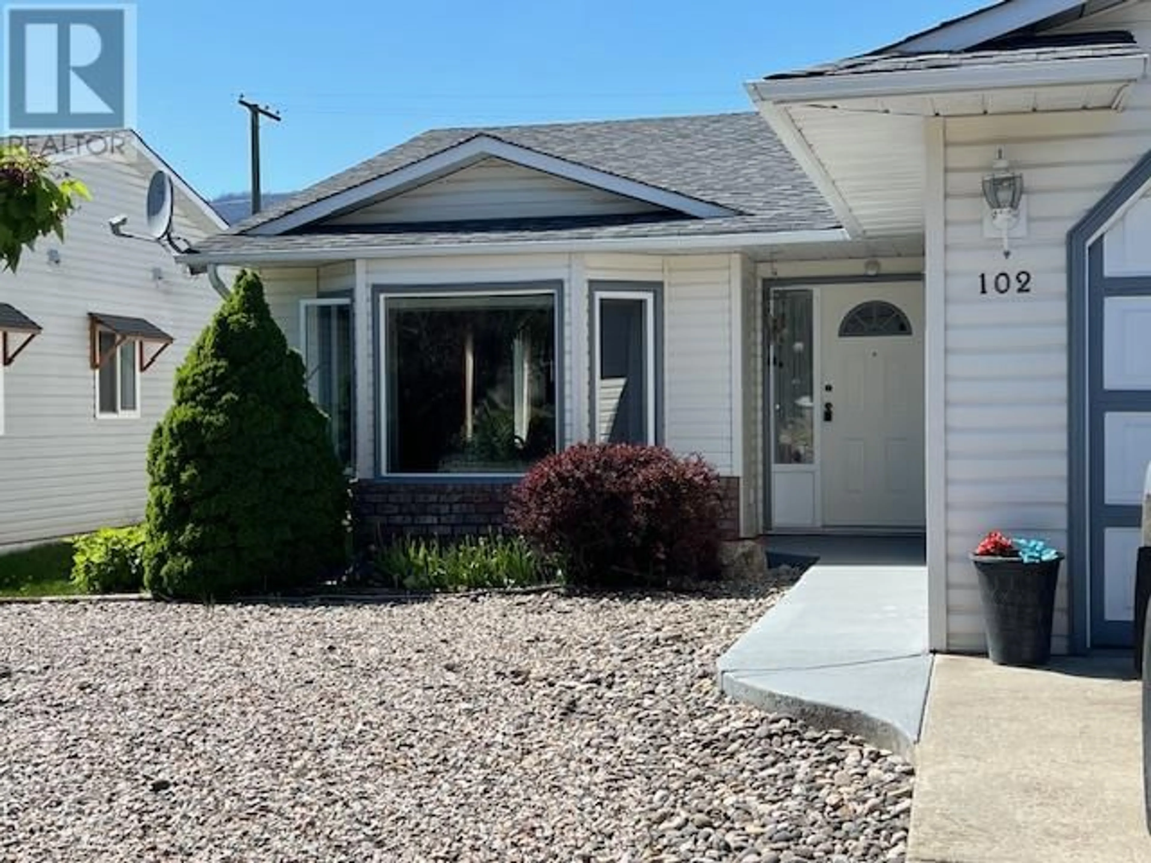 Home with vinyl exterior material, street for 102 1ST STREET, Vernon British Columbia V1H1Z1