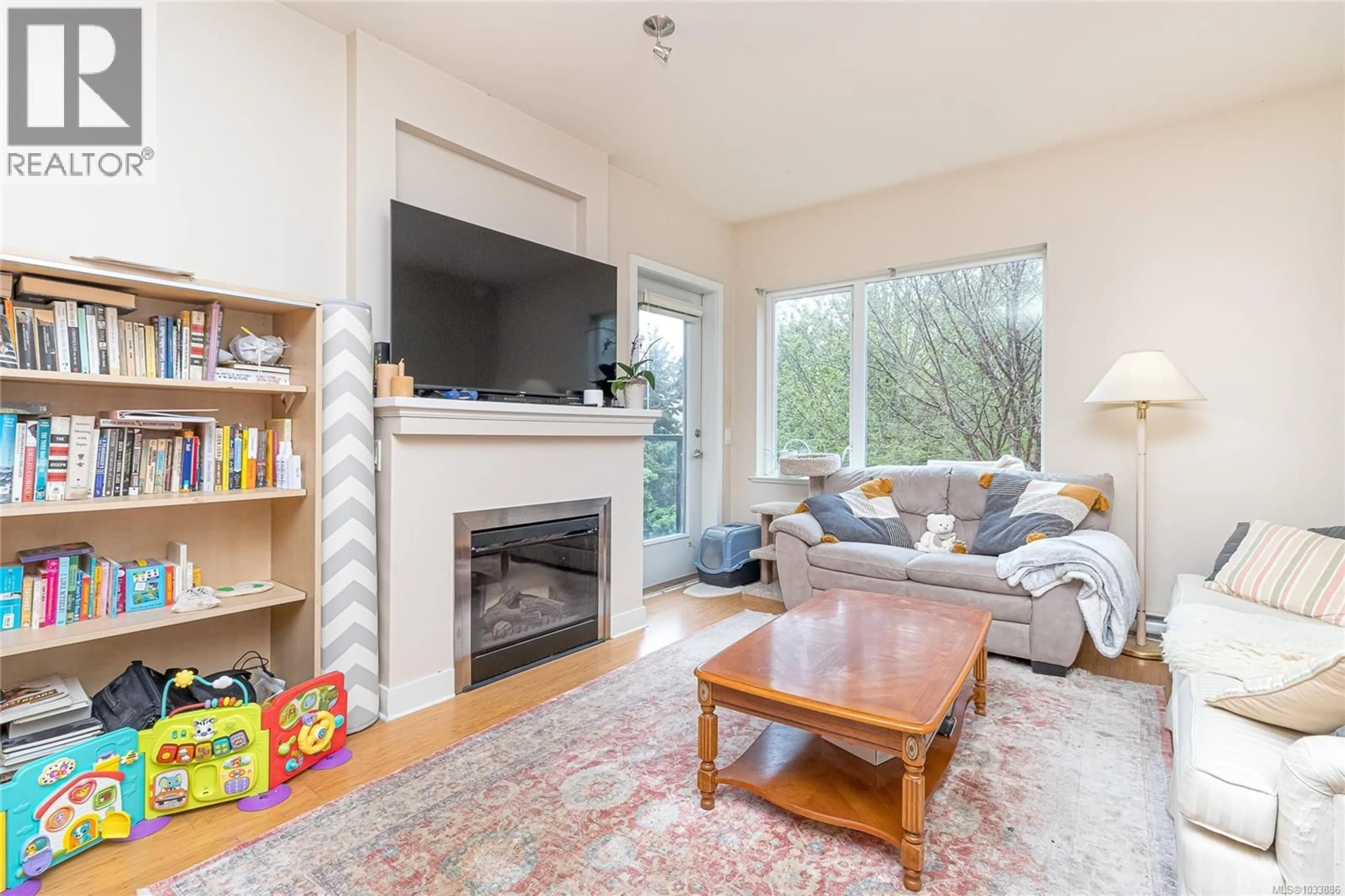 Living room with furniture, wood/laminate floor for 202 - 4394 WEST SAANICH ROAD, Saanich British Columbia V8Z0B5