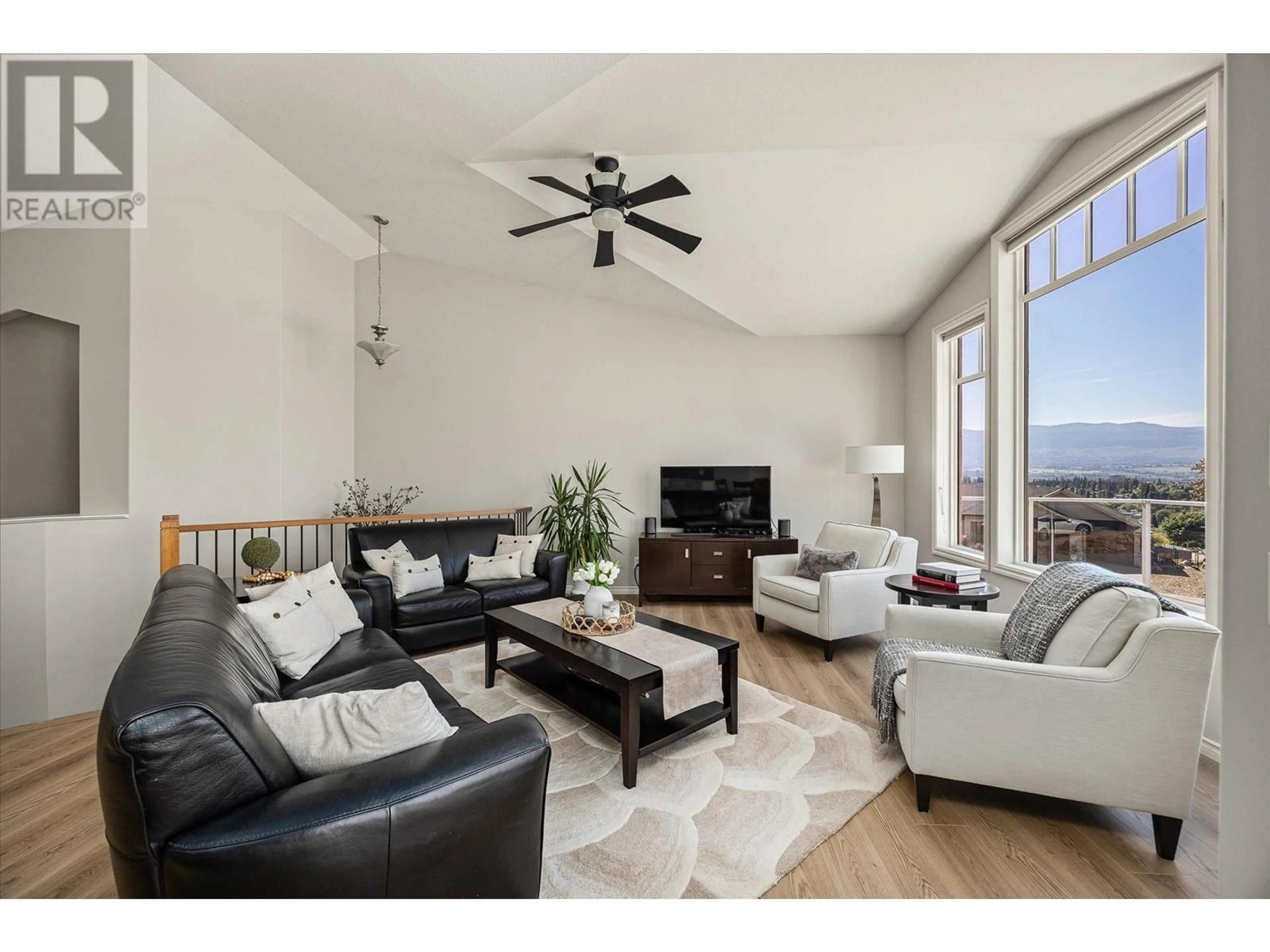 Living room with furniture, wood/laminate floor for 1750 MARKHAM COURT, Kelowna British Columbia V1V2W1