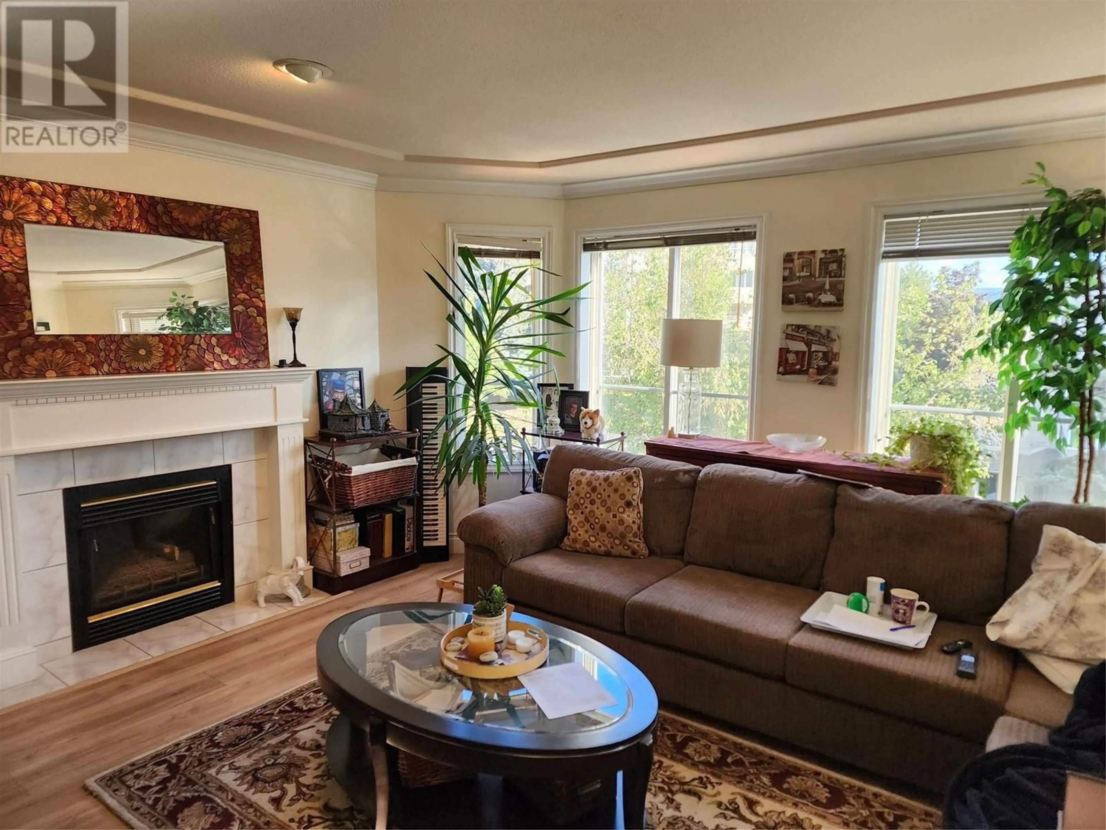 Living room with furniture, wood/laminate floor for 201 - 3220 CENTENNIAL DRIVE, Vernon British Columbia V1T2T7