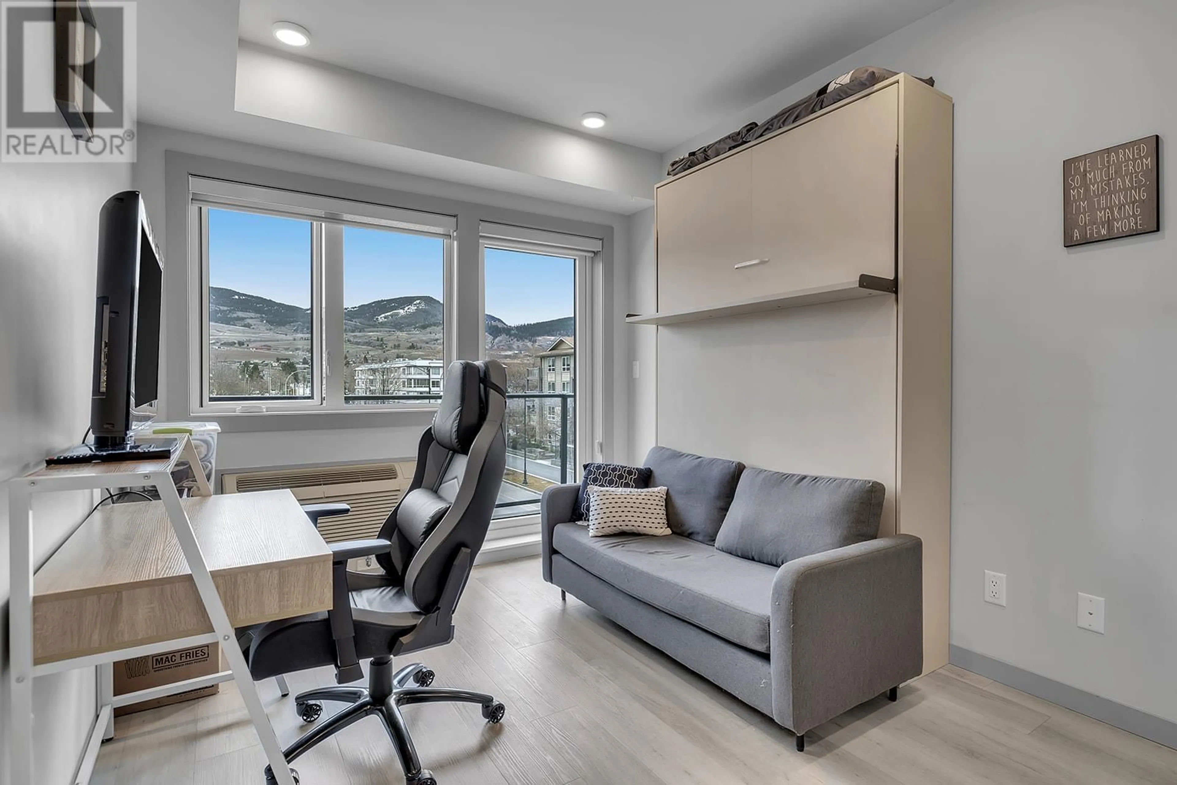 Living room with furniture, wood/laminate floor for 327 - 345 DOUGALL ROAD NORTH, Kelowna British Columbia V1X3K8