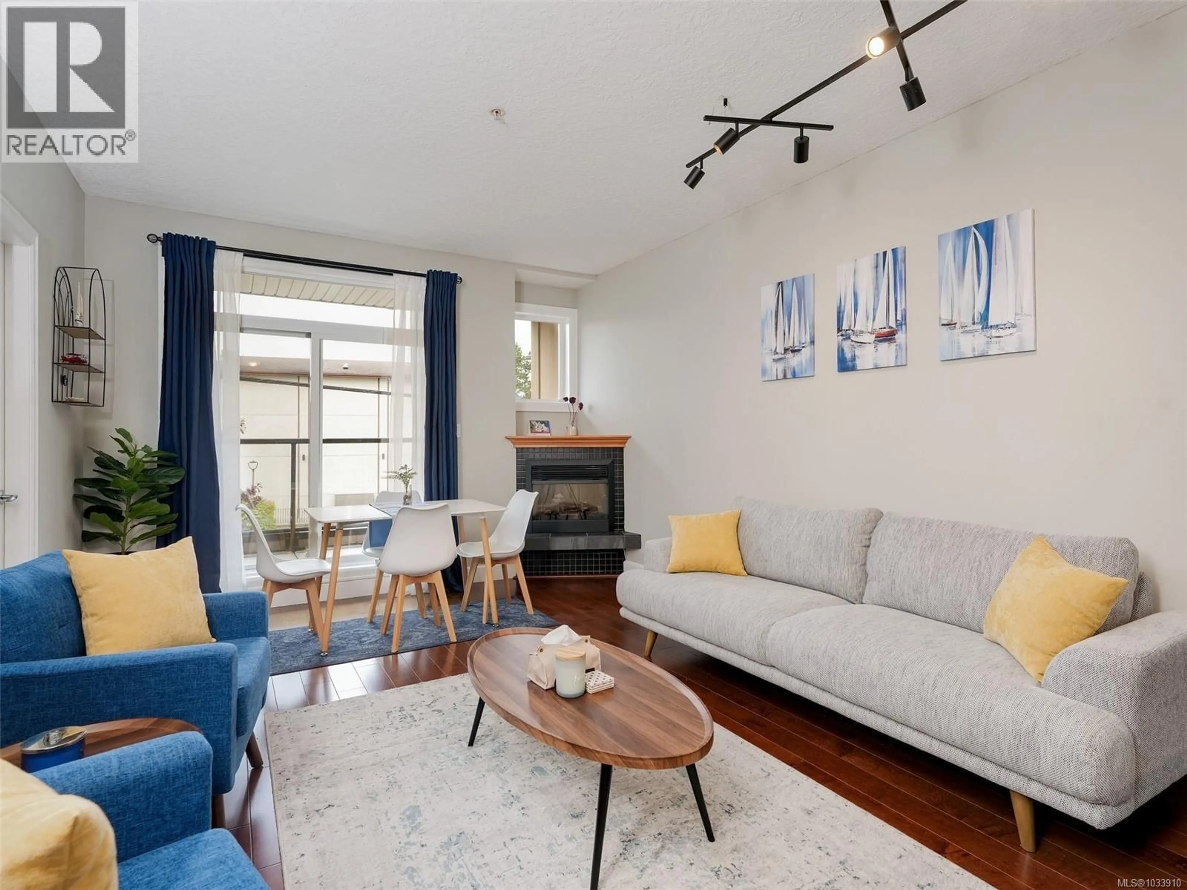 Living room with furniture, wood/laminate floor for 204 - 76 GORGE ROAD WEST, Saanich British Columbia V9A1M1