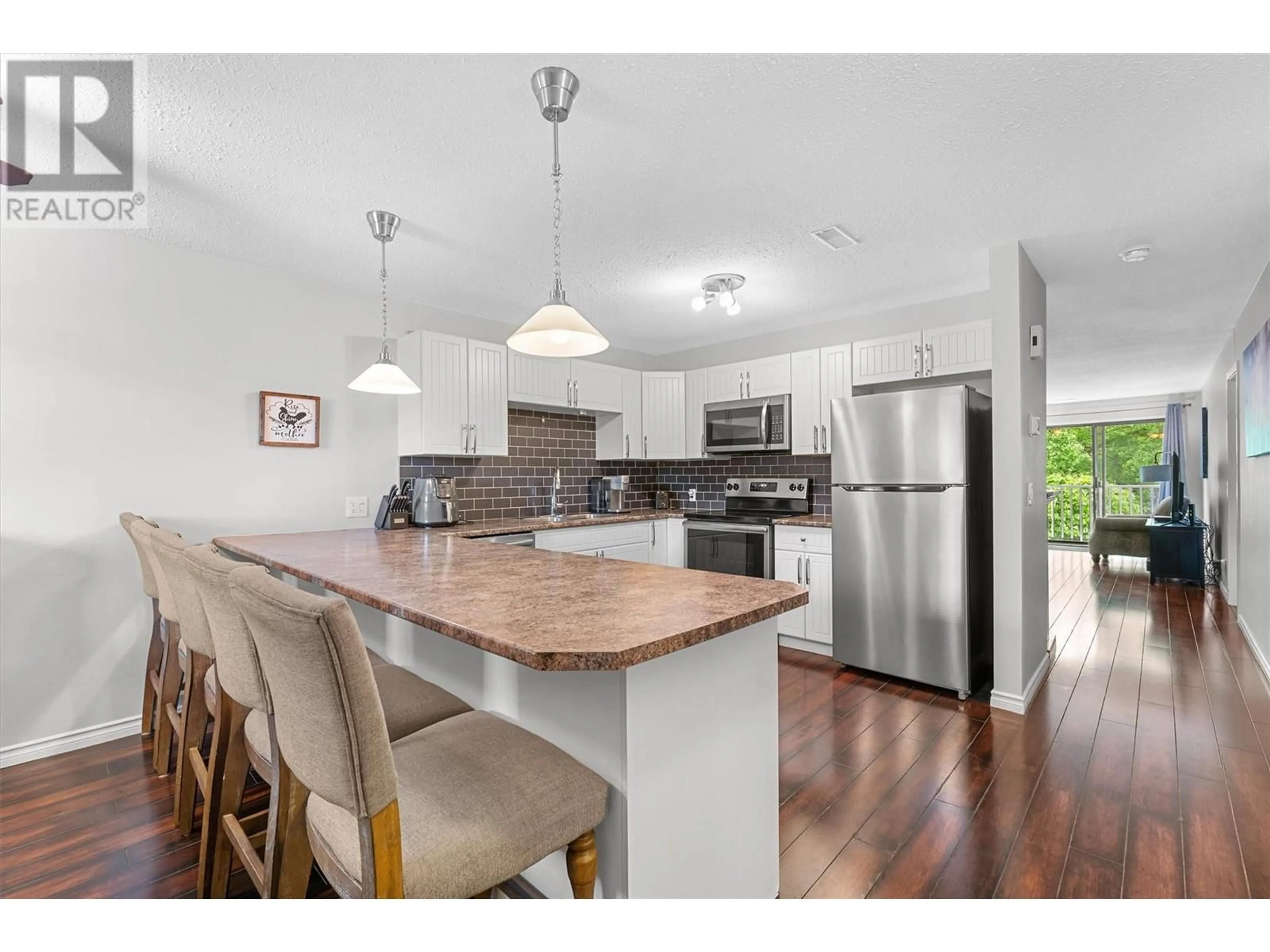 Open concept kitchen, wood/laminate floor for 211 - 3020 ALLENBY WAY, Vernon British Columbia V1T8L4