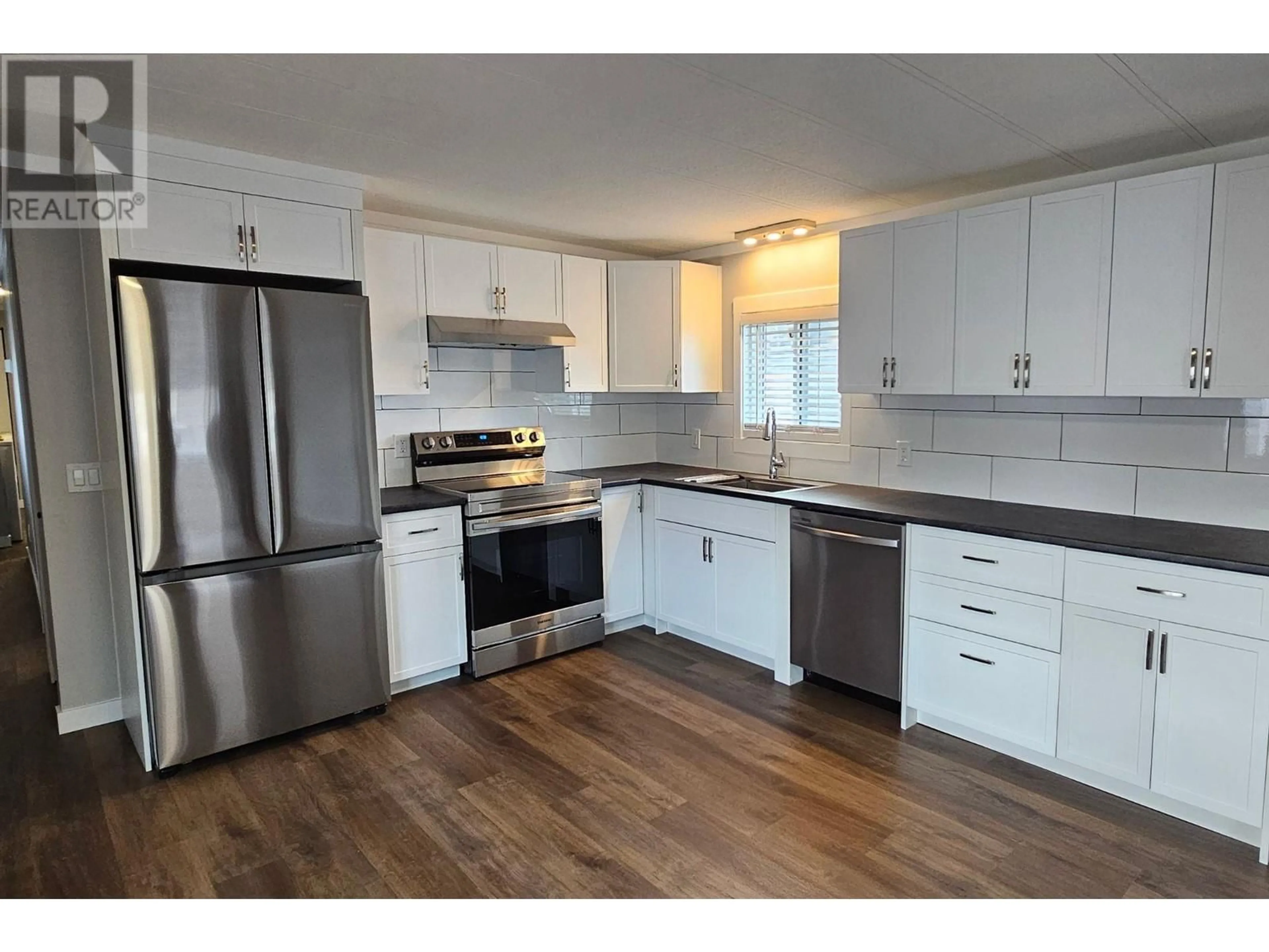Open concept kitchen, wood/laminate floor for 4 - 1401 NICOLA AVENUE, Merritt British Columbia V1K1L8