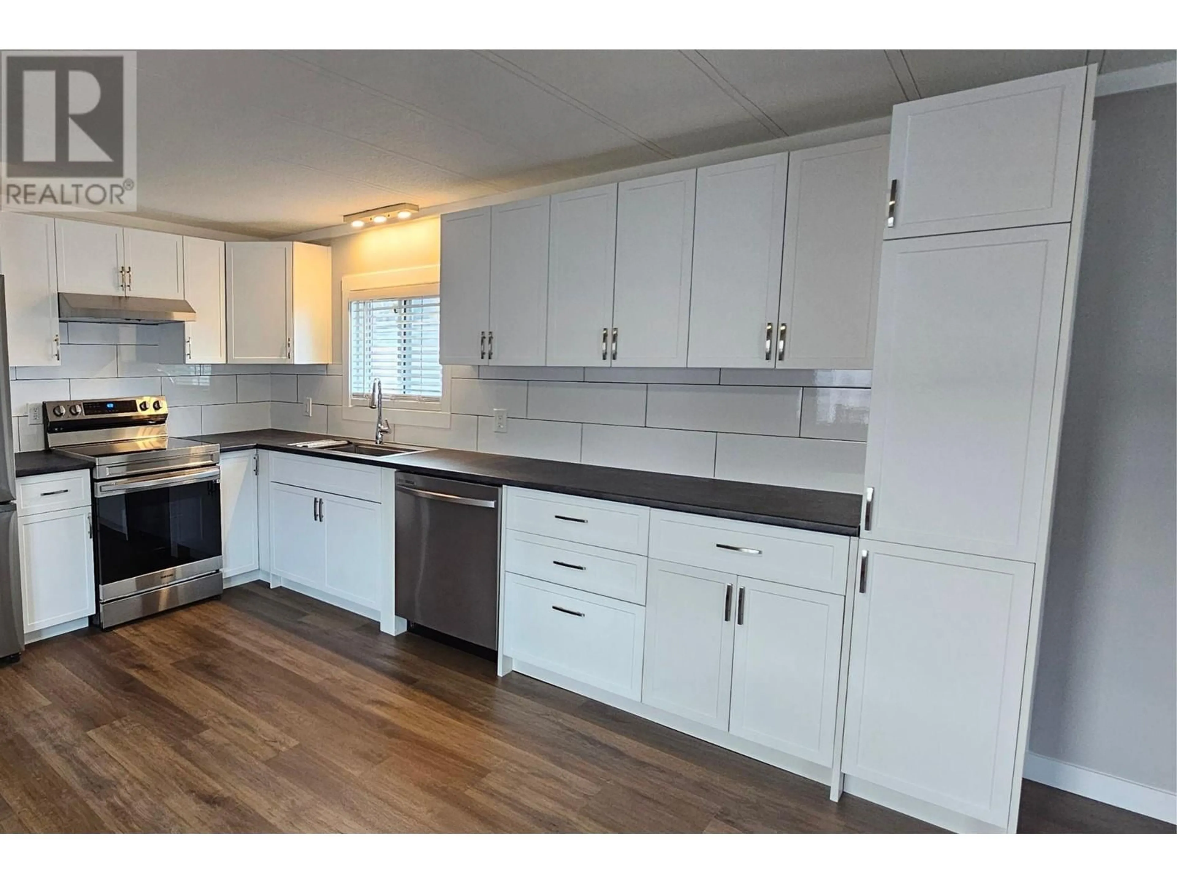 Open concept kitchen, wood/laminate floor for 4 - 1401 NICOLA AVENUE, Merritt British Columbia V1K1L8