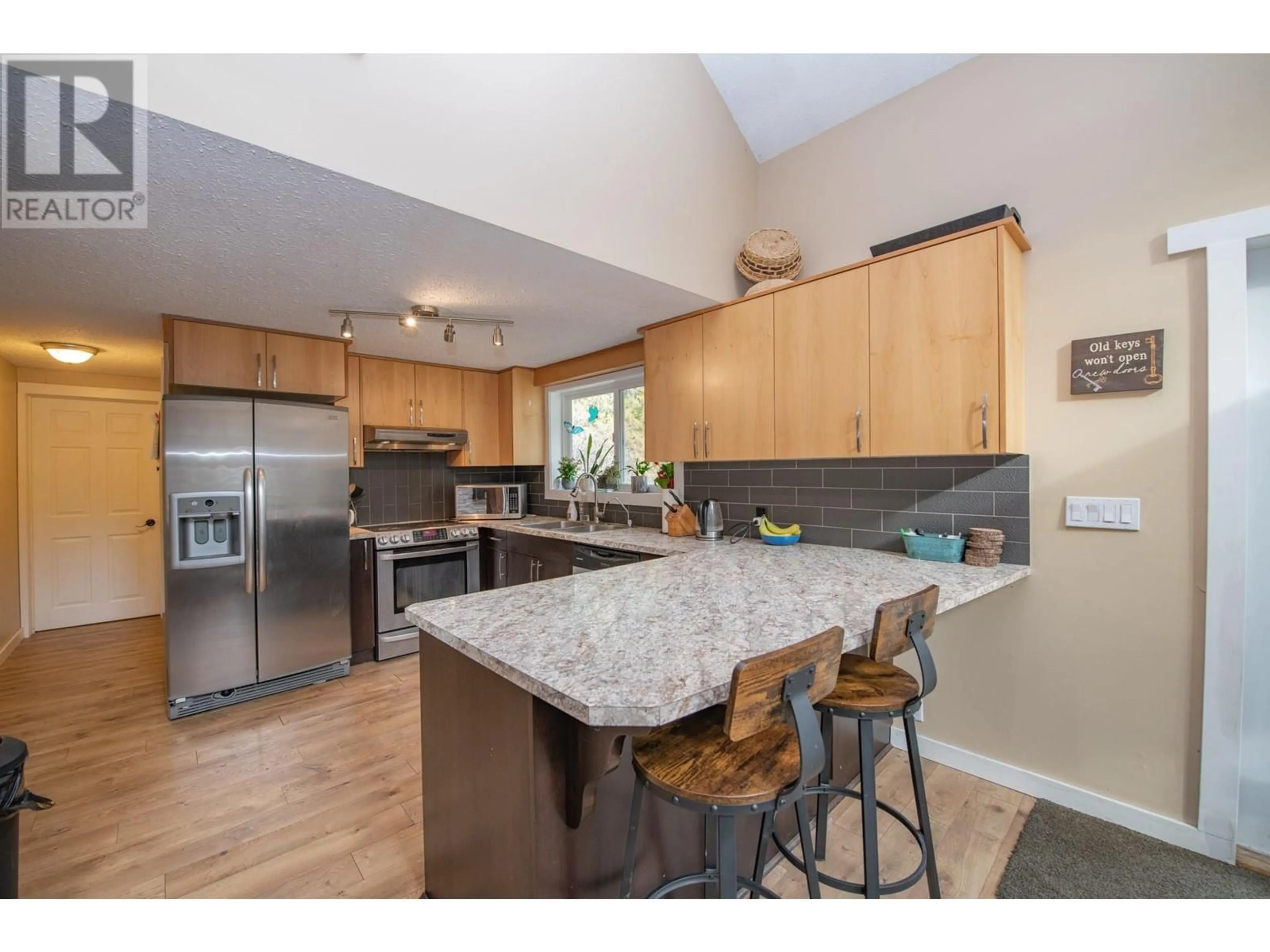 Open concept kitchen, wood/laminate floor for 1236 MABEL LAKE ROAD, Lumby British Columbia V0E2G5