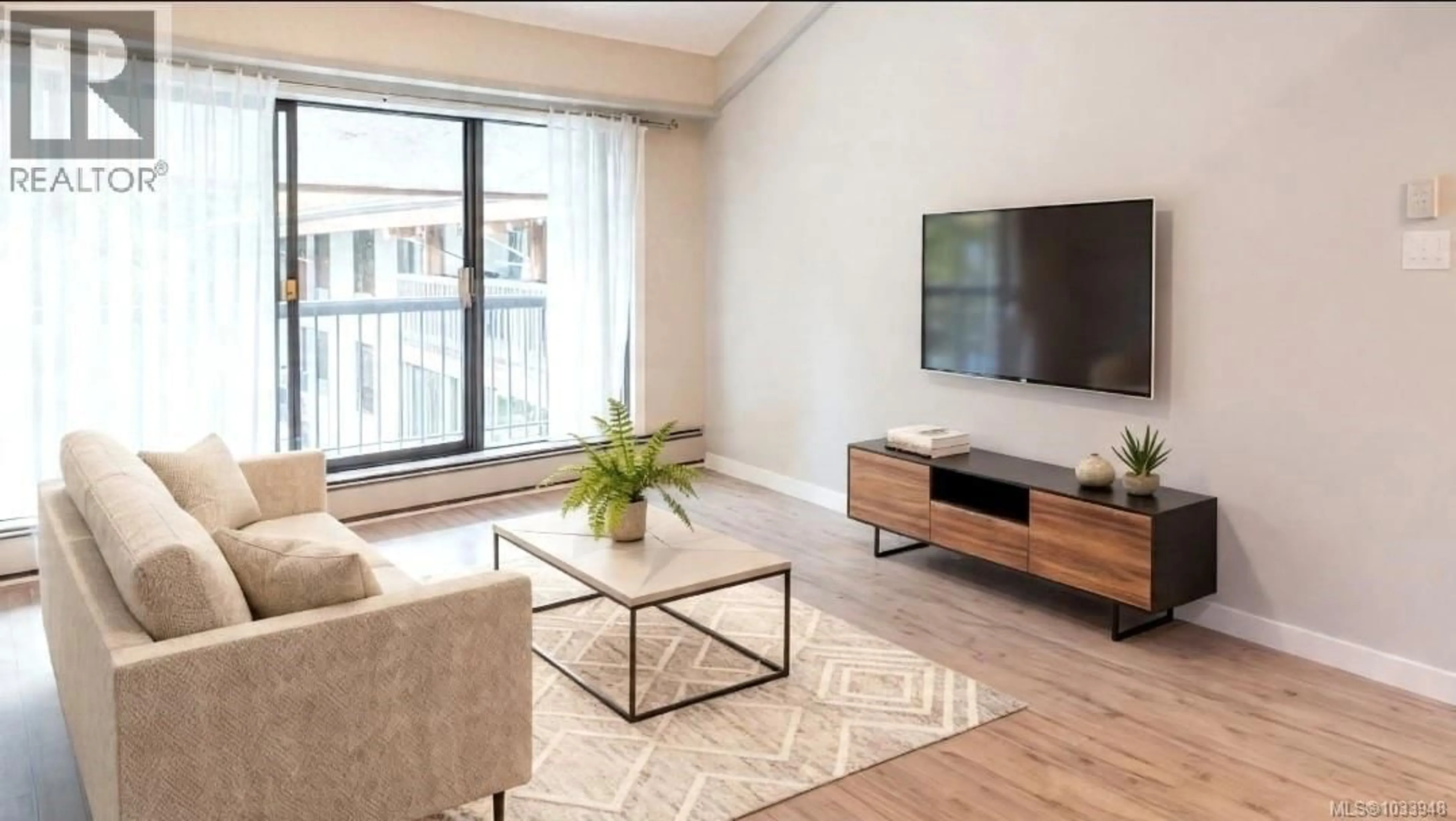 Living room with furniture, wood/laminate floor for 408 - 1005 MCKENZIE AVENUE, Saanich British Columbia V8X4A9