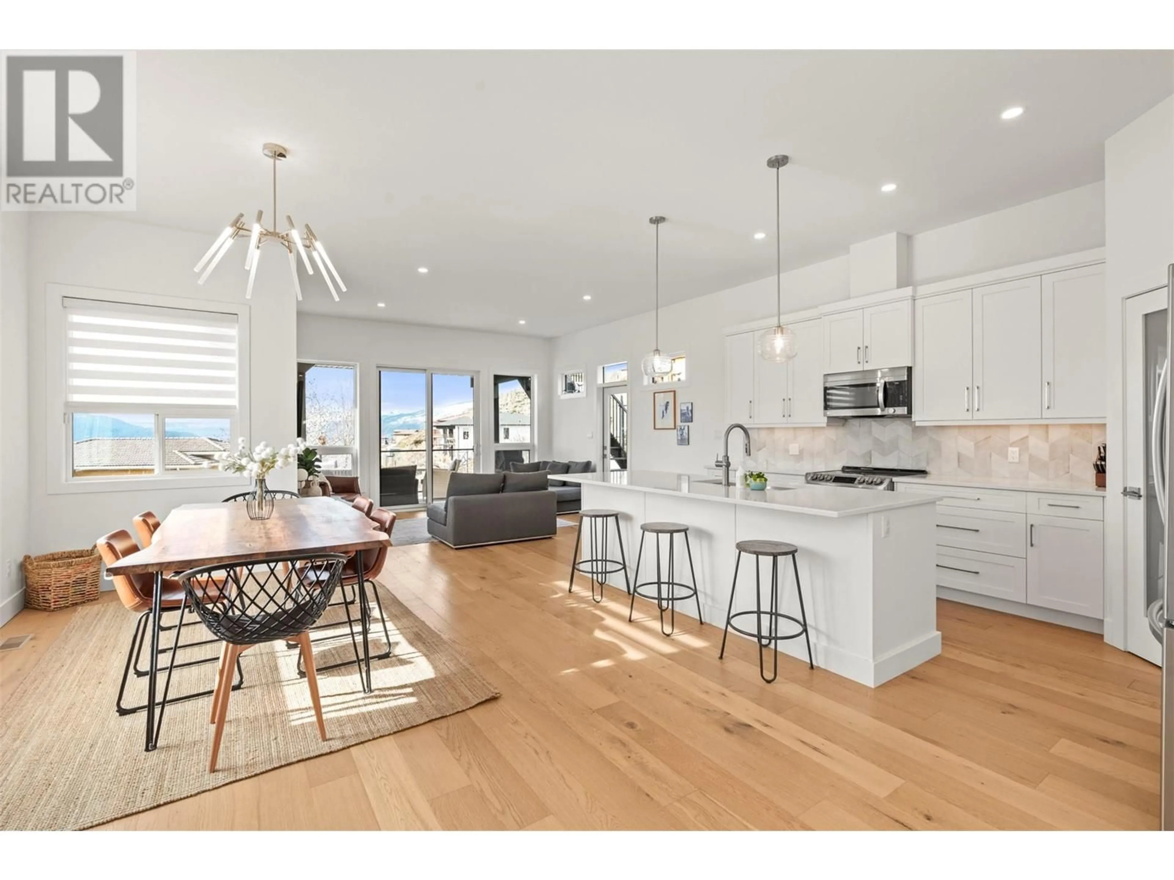 Open concept kitchen, wood/laminate floor for 305 CORDON PLACE, Vernon British Columbia V1H1Z9