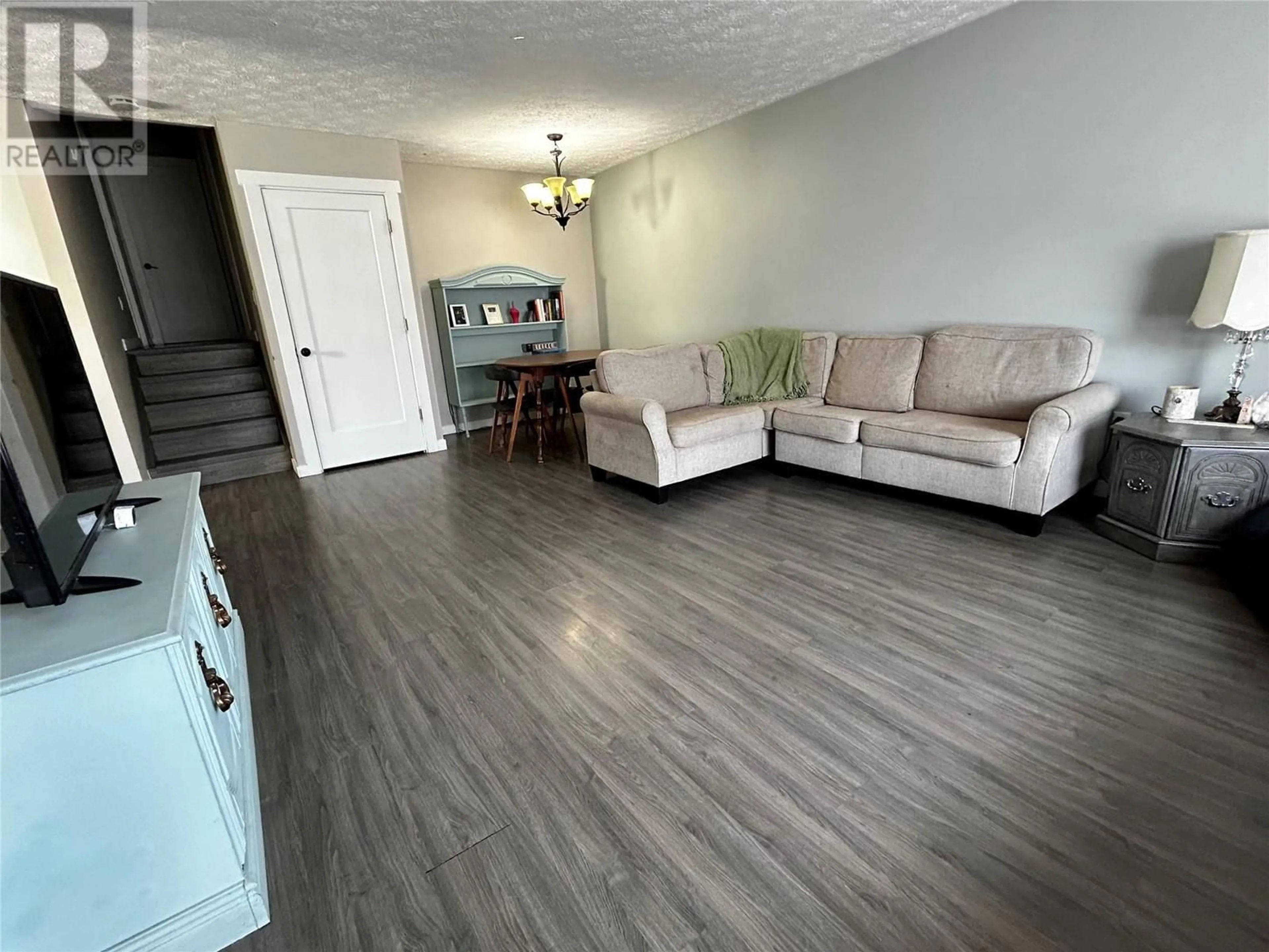 Living room with furniture, wood/laminate floor for 415 BERGERON DRIVE, Tumbler Ridge British Columbia V0C2W0