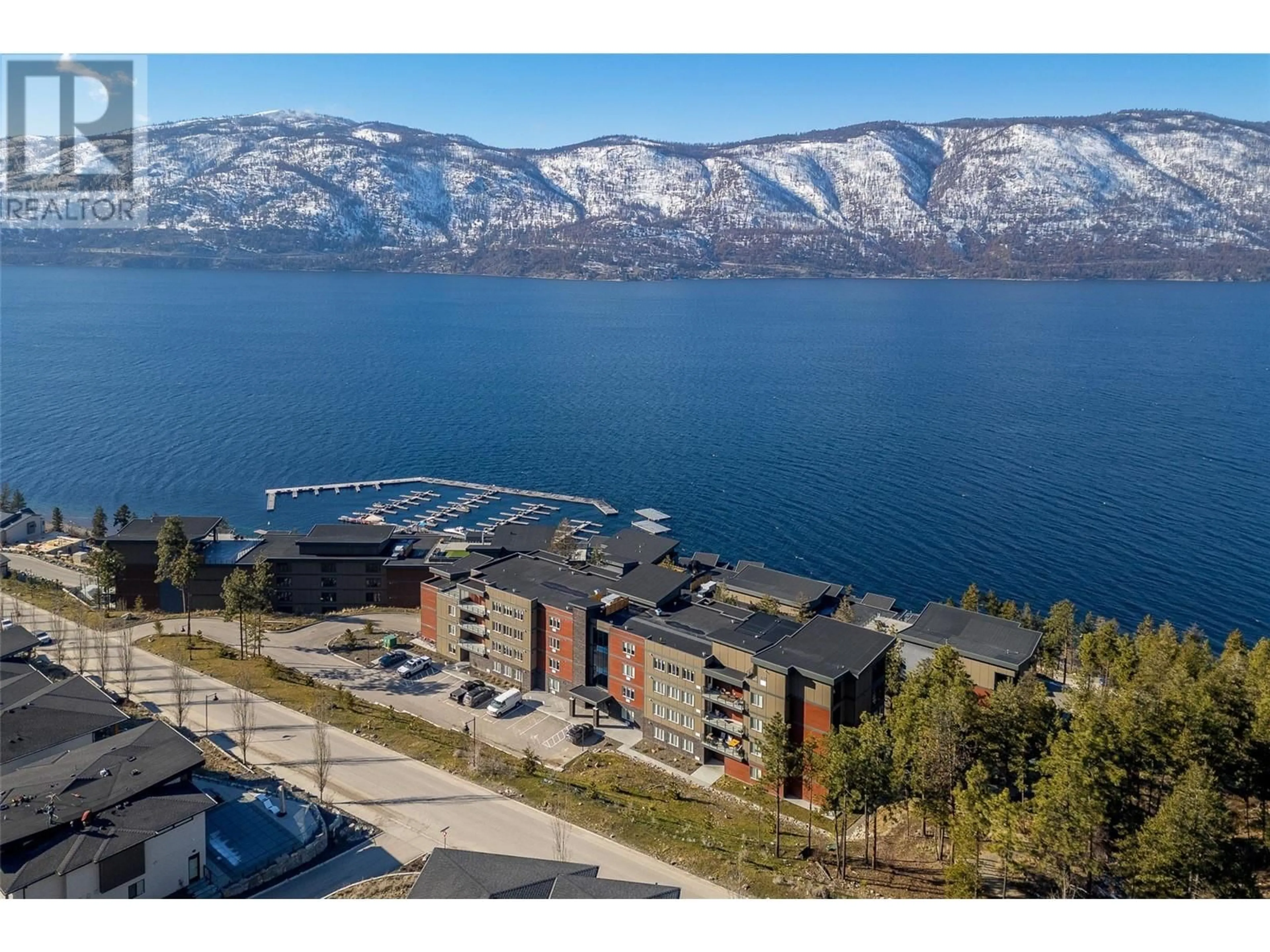 A pic from outside/outdoor area/front of a property/back of a property/a pic from drone, water/lake/river/ocean view for 206 - 3434 MCKINLEY BEACH DRIVE, Kelowna British Columbia V1V0H3