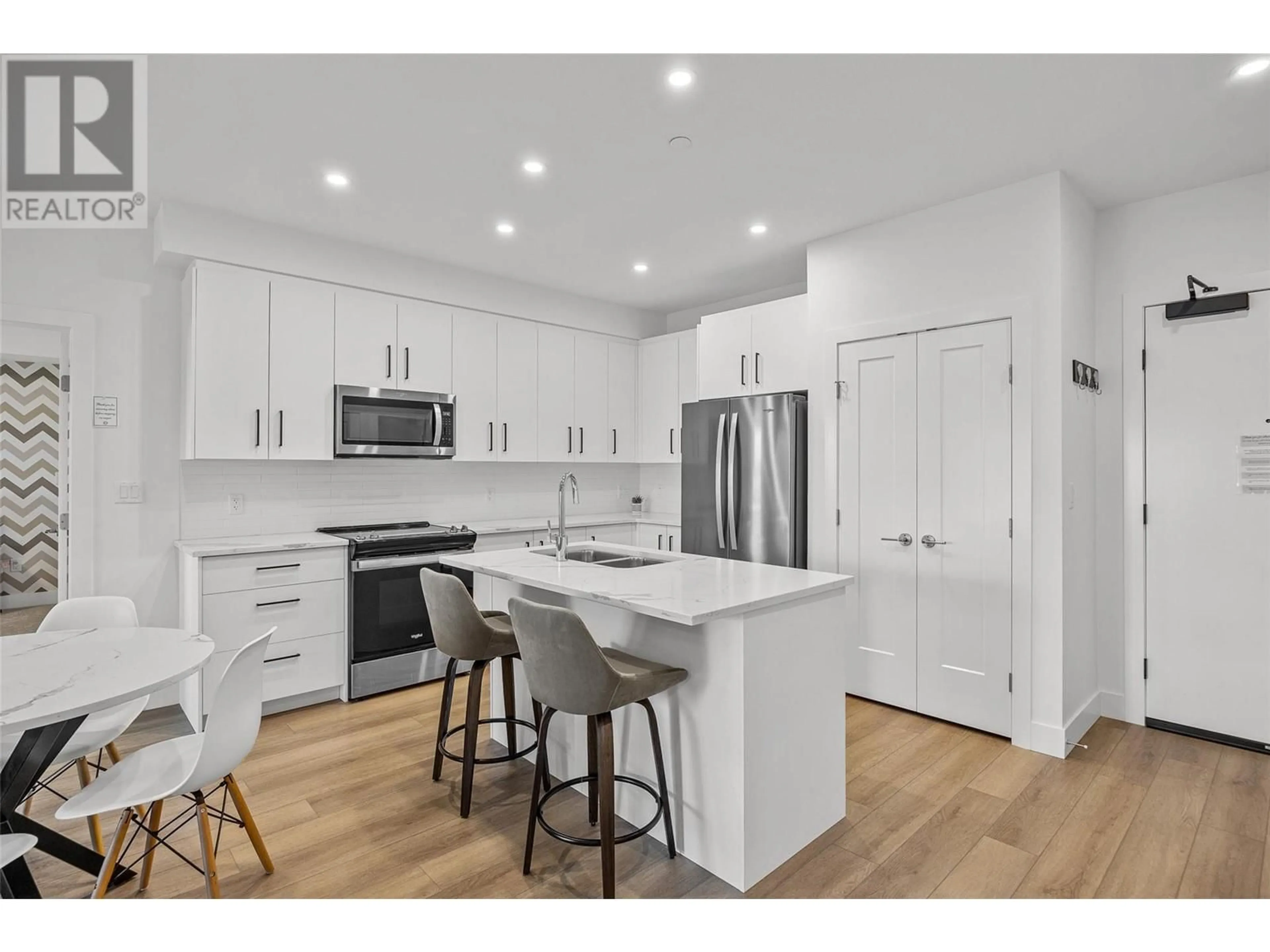Open concept kitchen, wood/laminate floor for 206 - 3434 MCKINLEY BEACH DRIVE, Kelowna British Columbia V1V0H3