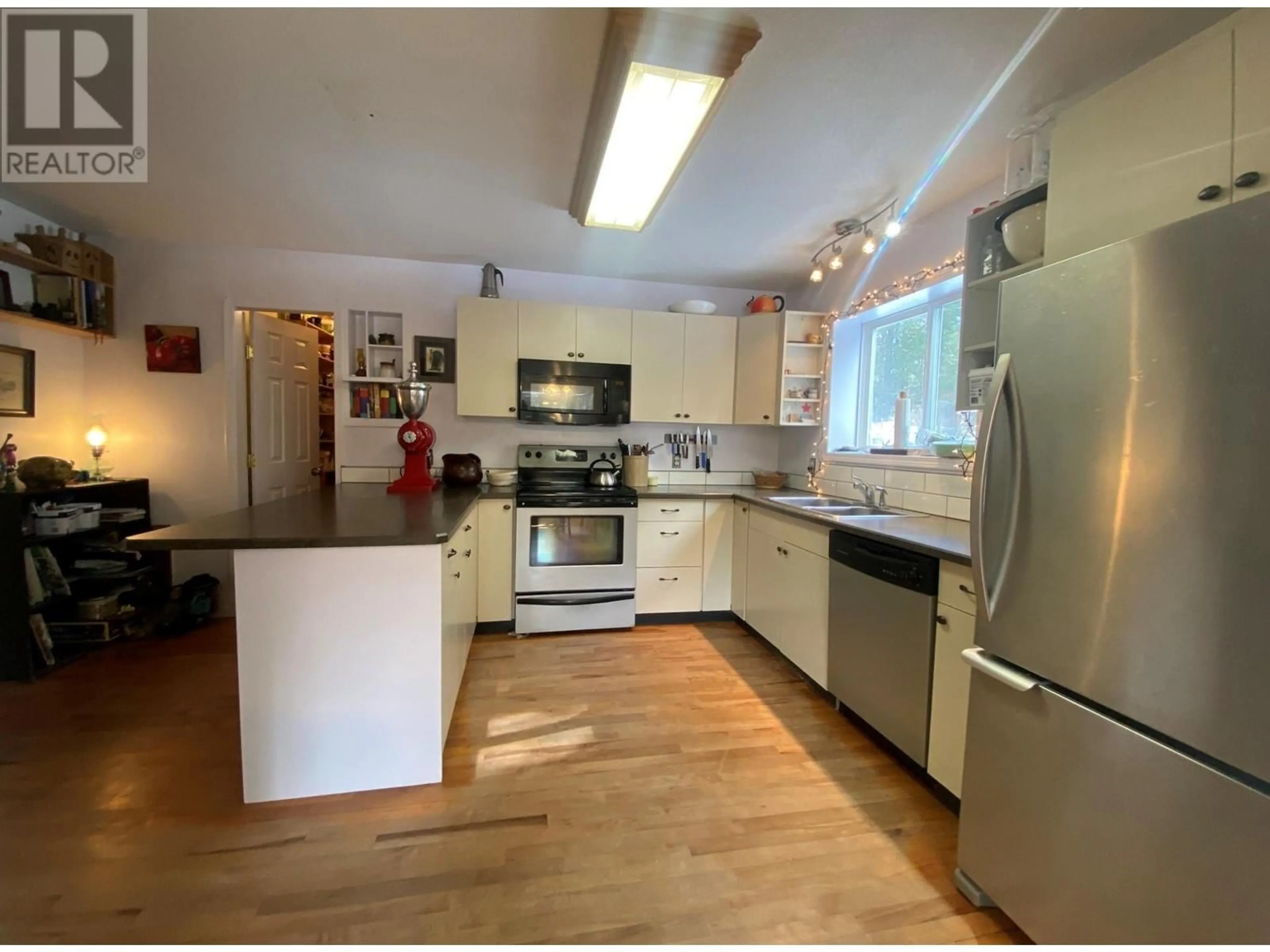 Open concept kitchen, wood/laminate floor for 10625 GRANBY ROAD, Grand Forks British Columbia V0H1H1