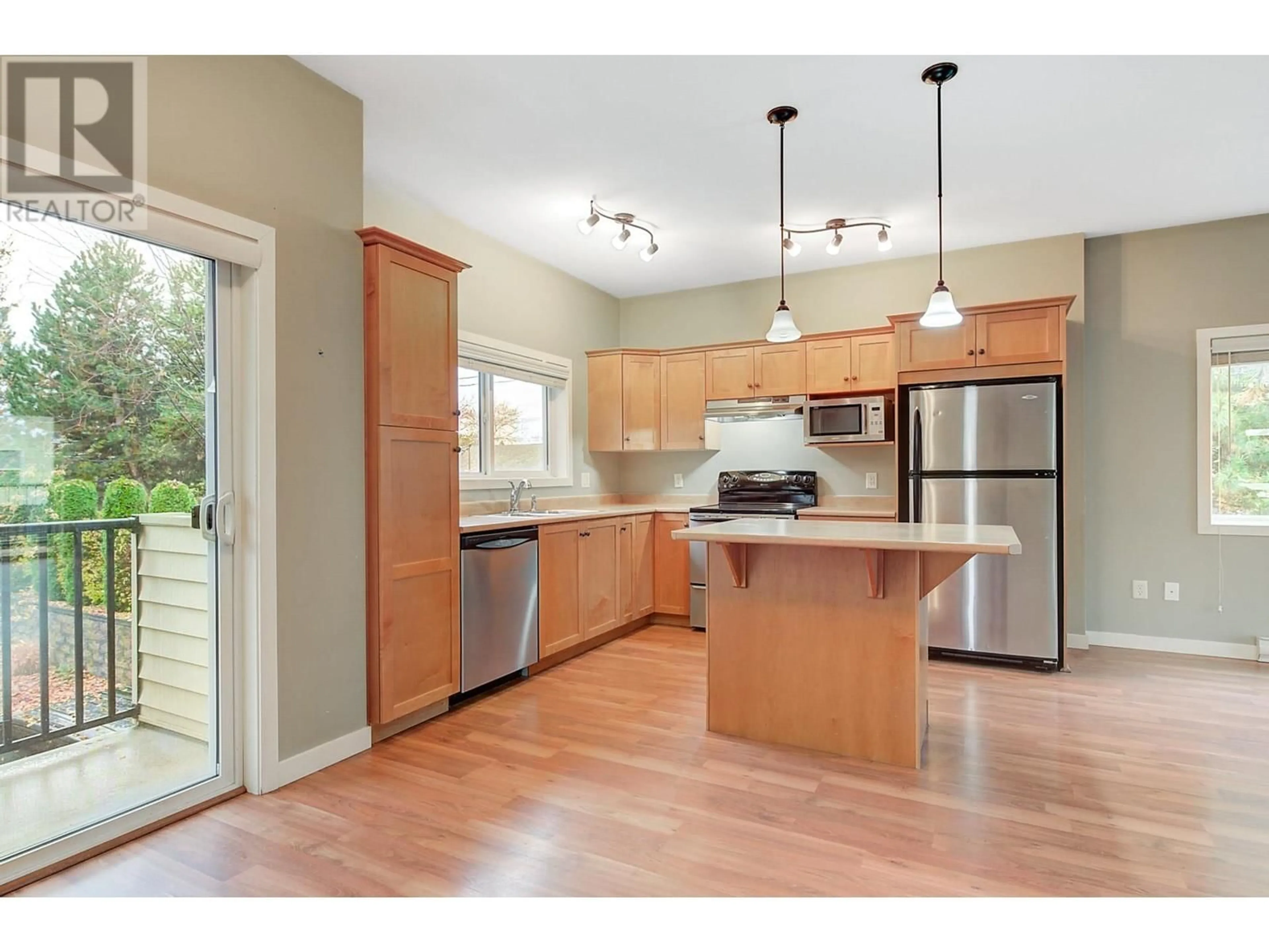 Open concept kitchen, wood/laminate floor for 101 - 150 MALLACH ROAD, Kelowna British Columbia V1X8C2