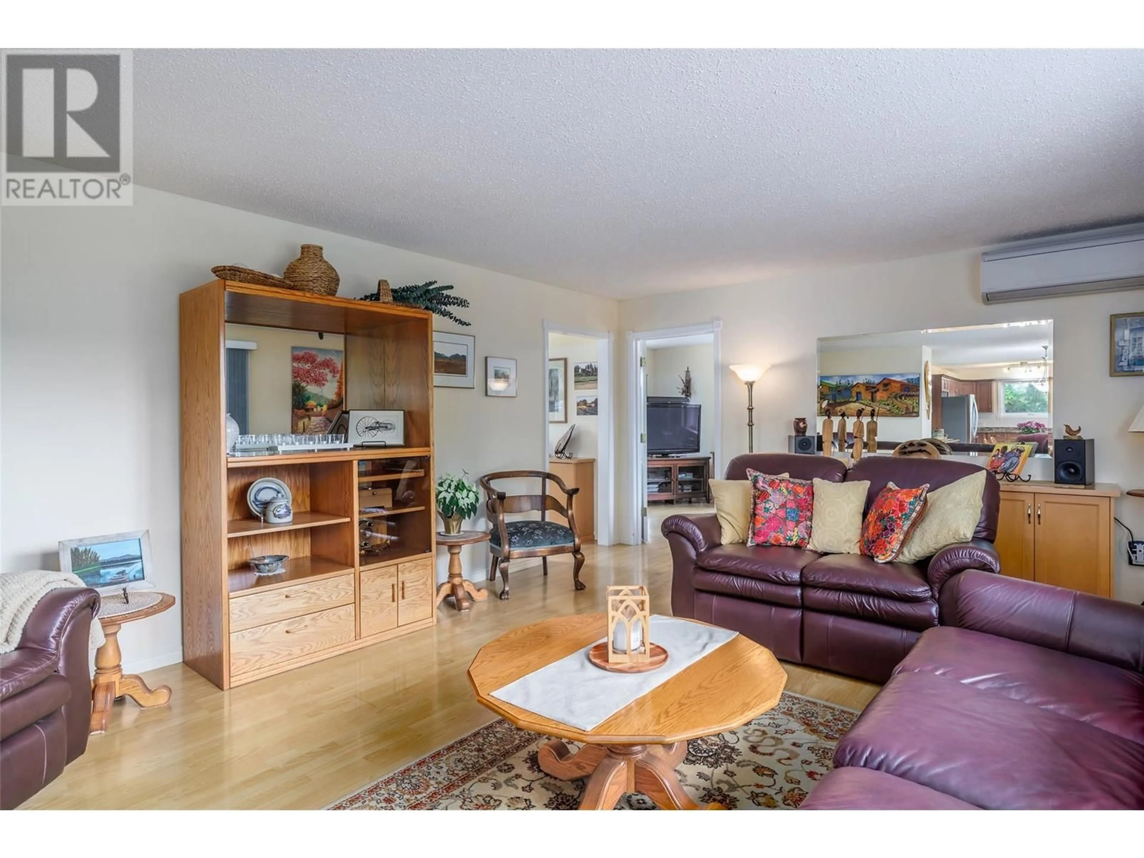 Living room with furniture, wood/laminate floor for 1789 MUNSON ROAD, Kelowna British Columbia V1W2G8