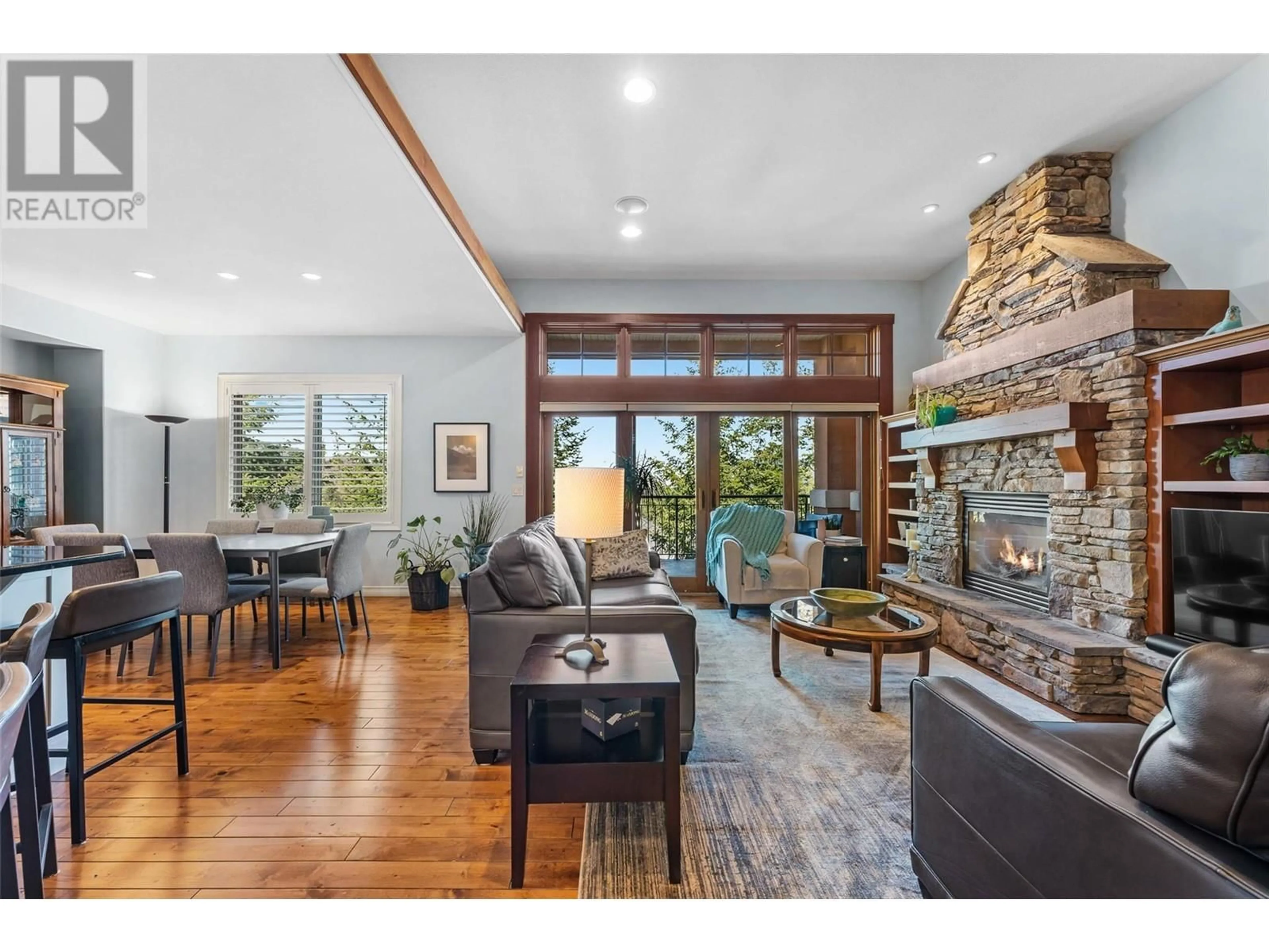 Living room with furniture, wood/laminate floor for 108 - 1910 CAPISTRANO DRIVE, Kelowna British Columbia V1V2S5