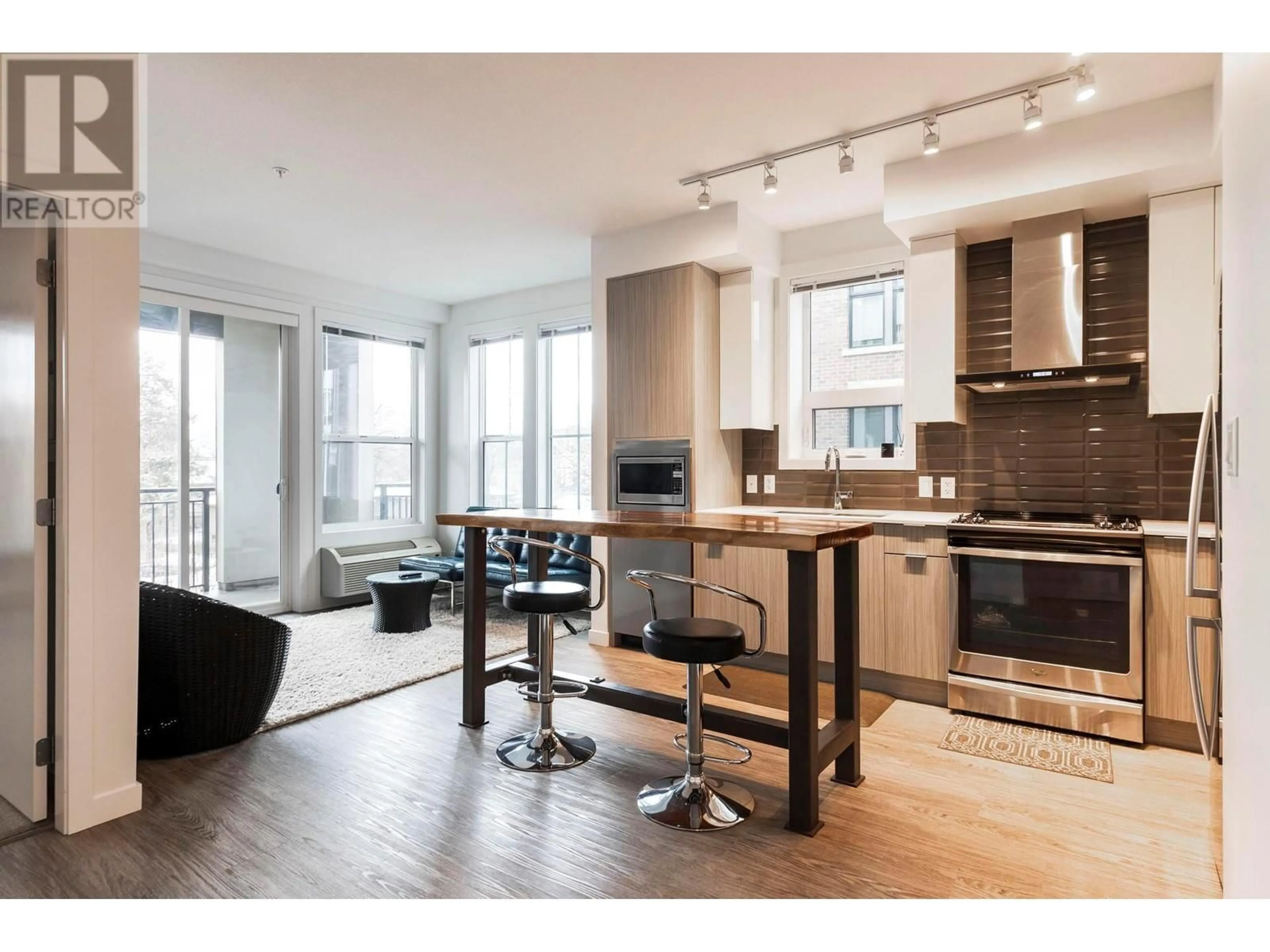 Open concept kitchen, wood/laminate floor for 206 - 1770 RICHTER STREET, Kelowna British Columbia V1Y0E6
