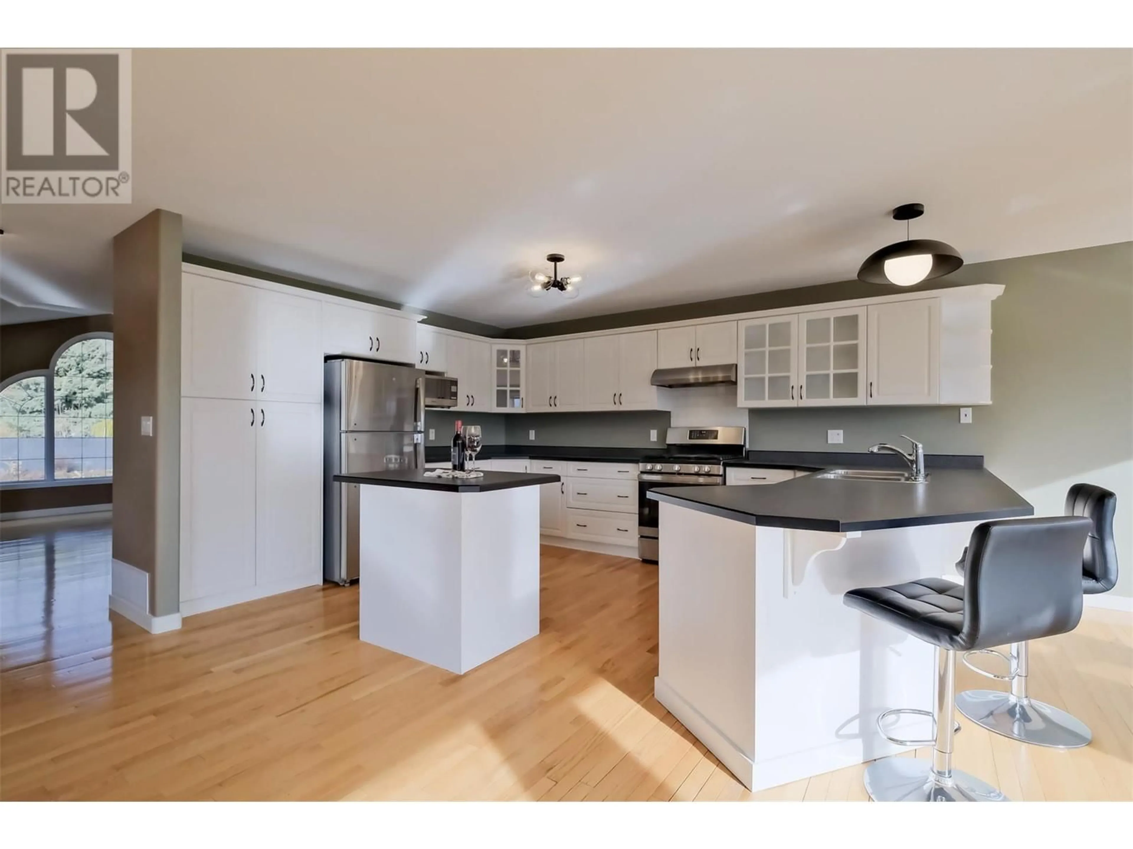 Open concept kitchen, wood/laminate floor for 1893 SANDSTONE DRIVE, Penticton British Columbia V2A8Y6