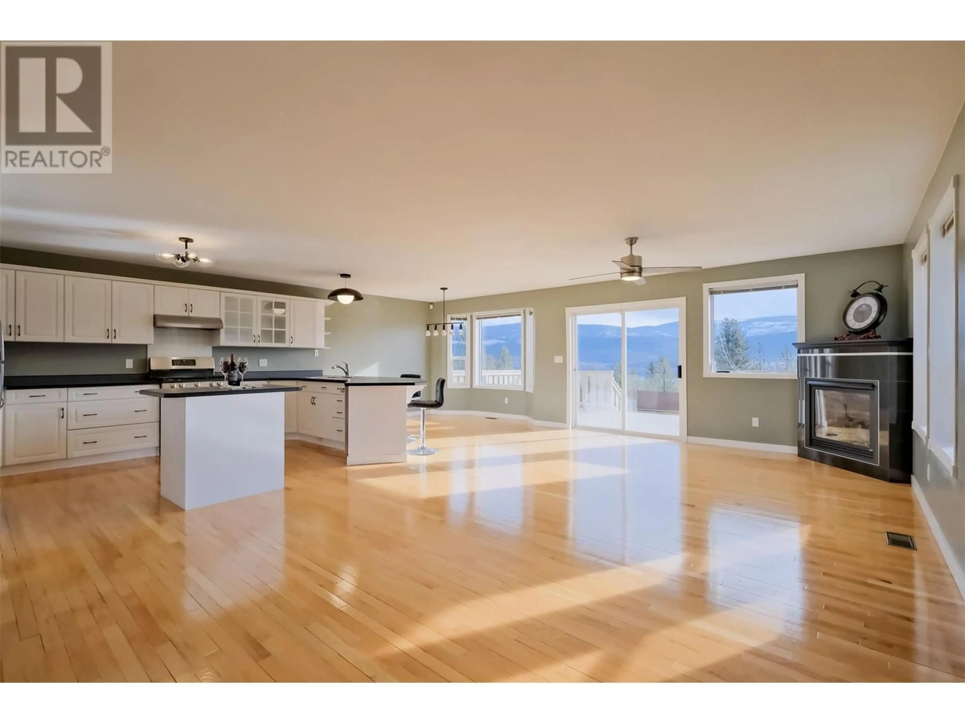 Open concept kitchen, wood/laminate floor for 1893 SANDSTONE DRIVE, Penticton British Columbia V2A8Y6