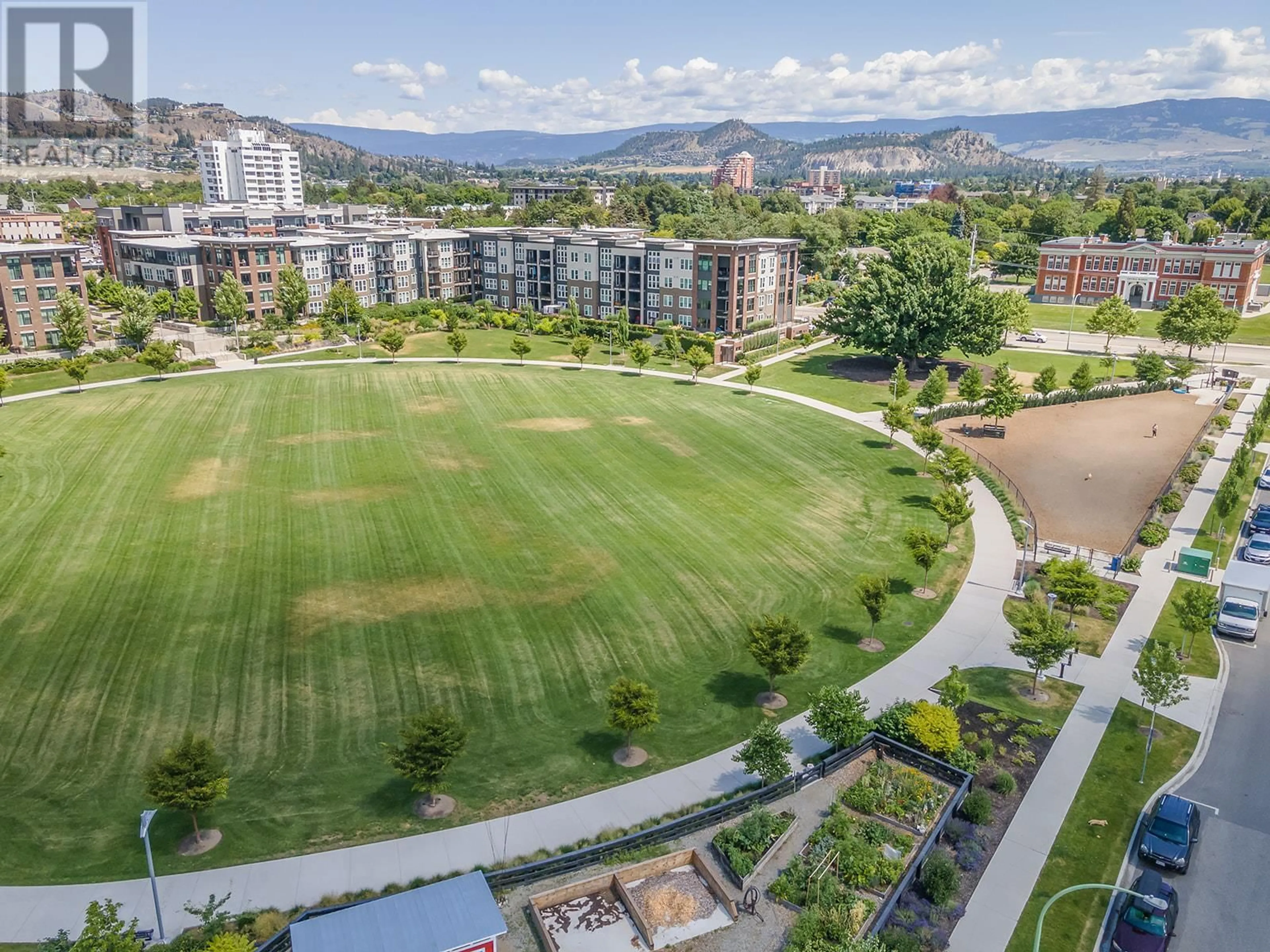 A pic from outside/outdoor area/front of a property/back of a property/a pic from drone, mountain view for 206 - 555 ROWCLIFFE AVENUE, Kelowna British Columbia V1Y5Y8