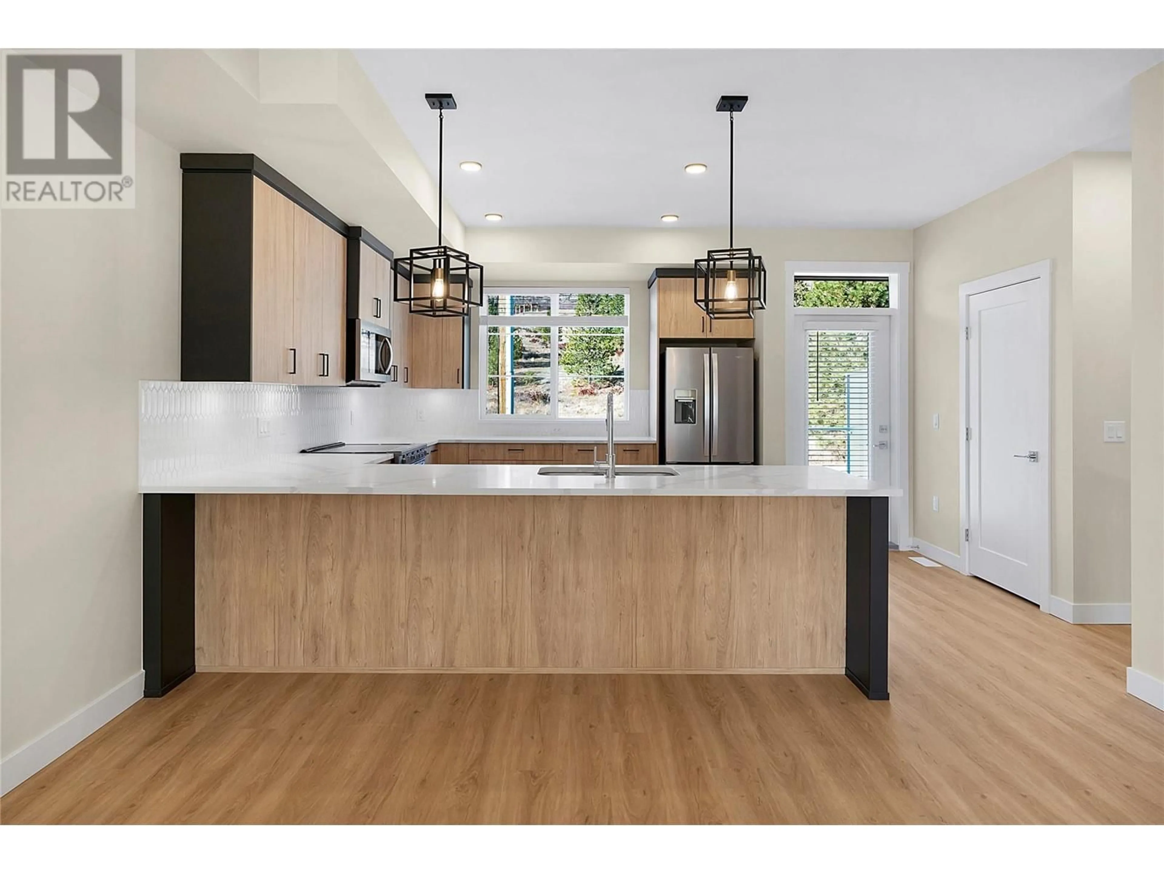 Open concept kitchen, wood/laminate floor for 179 - 4025 GELLATLY ROAD SOUTH, West Kelowna British Columbia V4T0E6