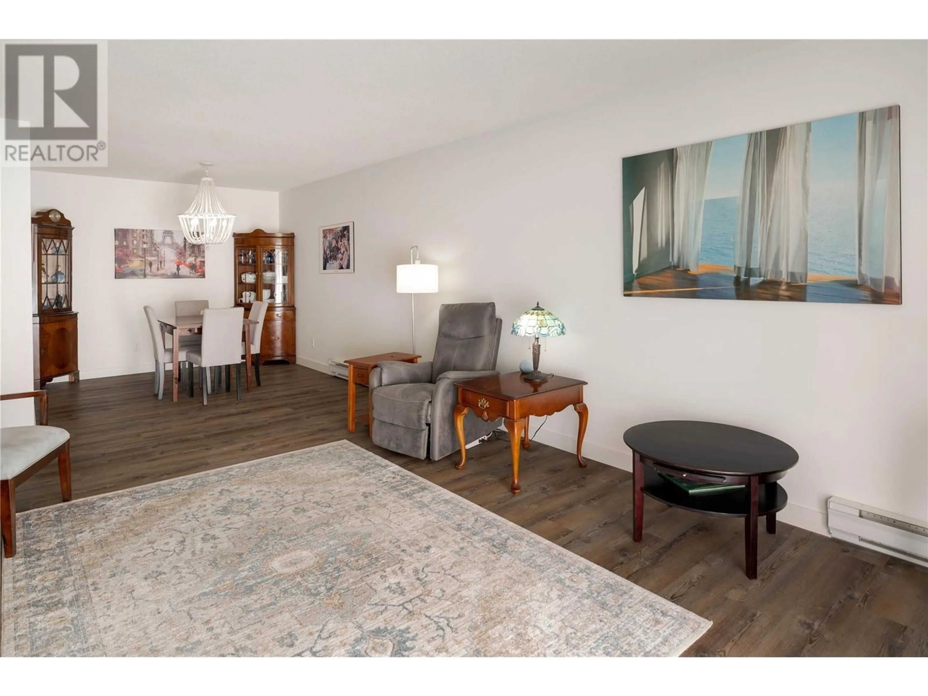 Living room with furniture, wood/laminate floor for 405 - 240 HOLLYWOOD ROAD NORTH, Kelowna British Columbia V1X6Y9