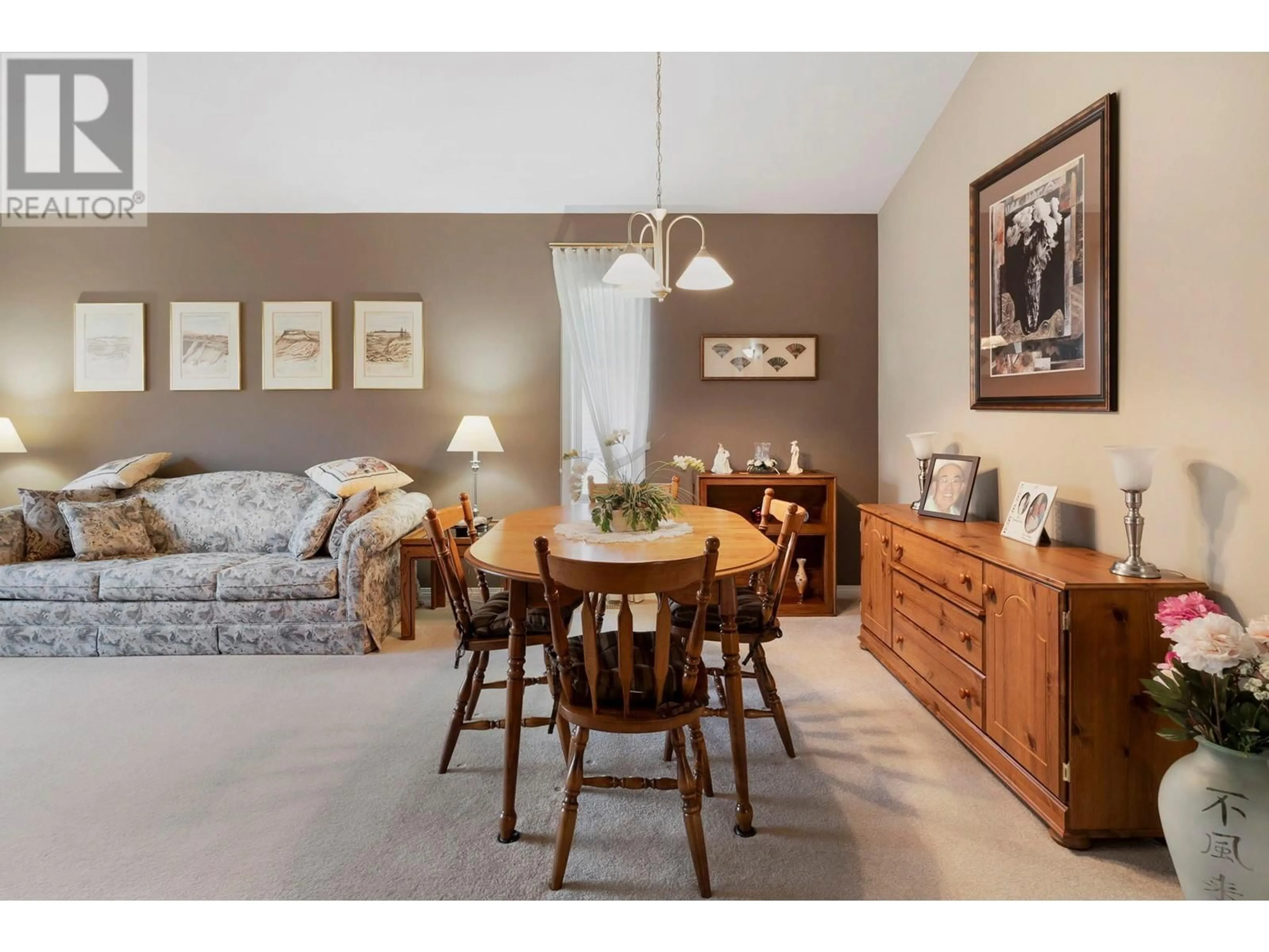 Living room with furniture, wood/laminate floor for 355 - 550 YATES ROAD, Kelowna British Columbia V1V1Z4