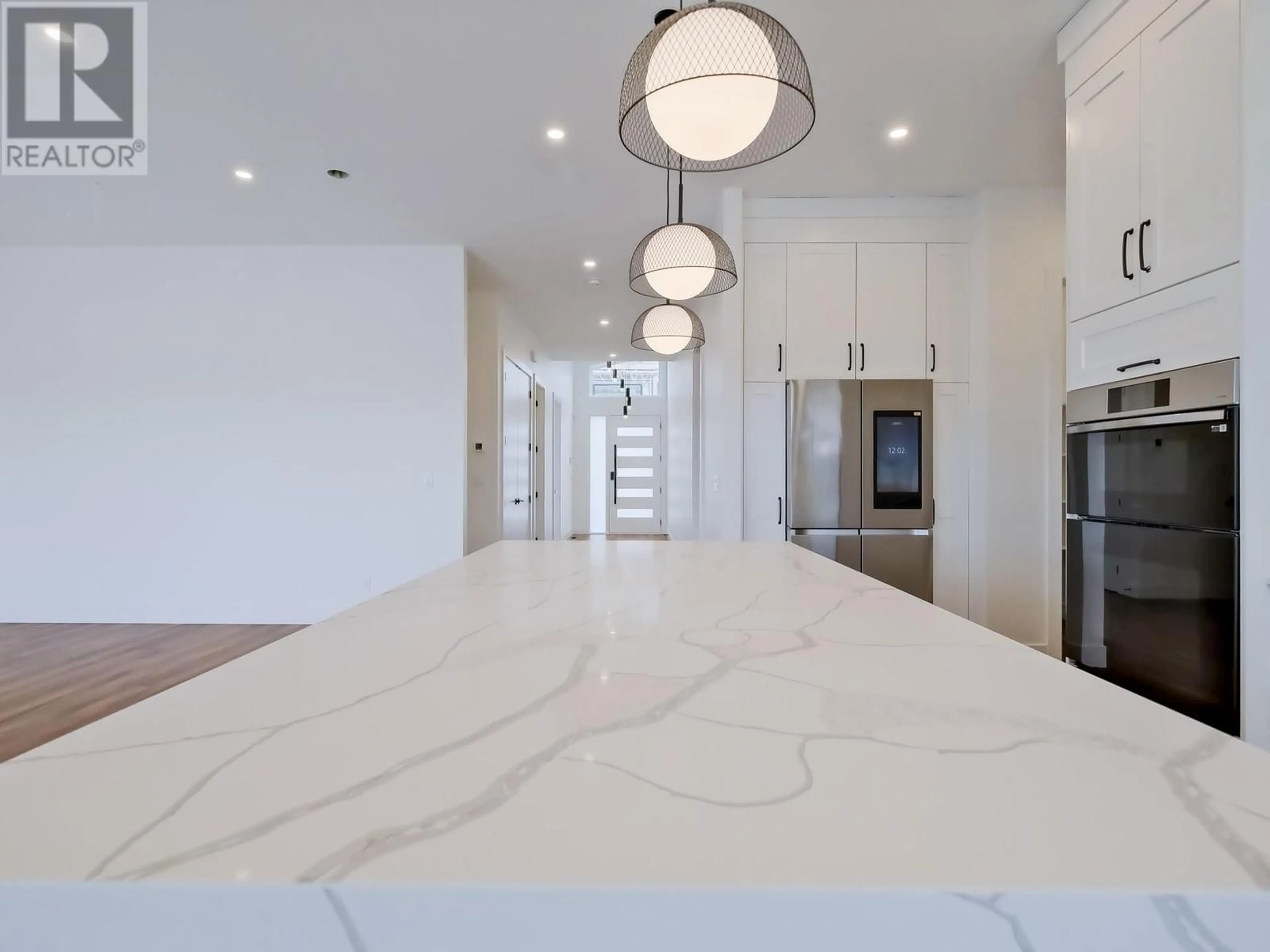 Open concept kitchen, wood/laminate floor for 1097 ANTLER DRIVE, Penticton British Columbia V2A0C8