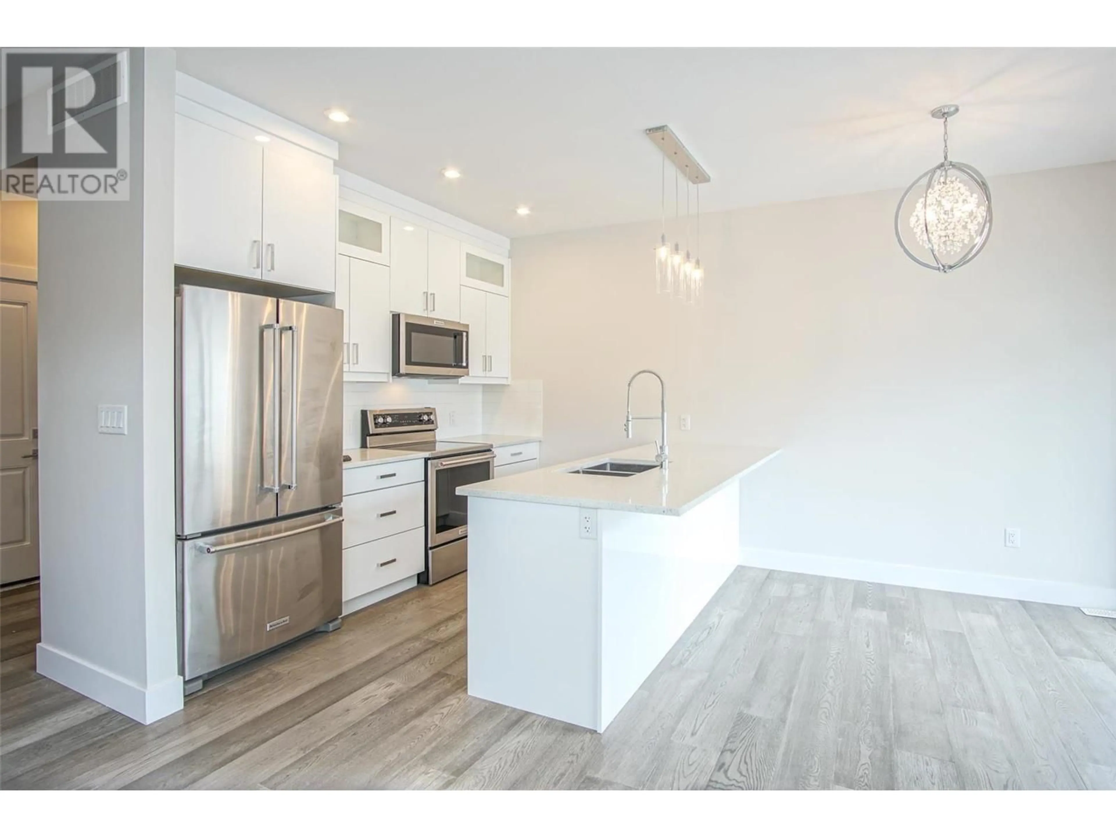 Open concept kitchen, wood/laminate floor for 1 - 415 RUTLAND ROAD, Kelowna British Columbia V1X3B3