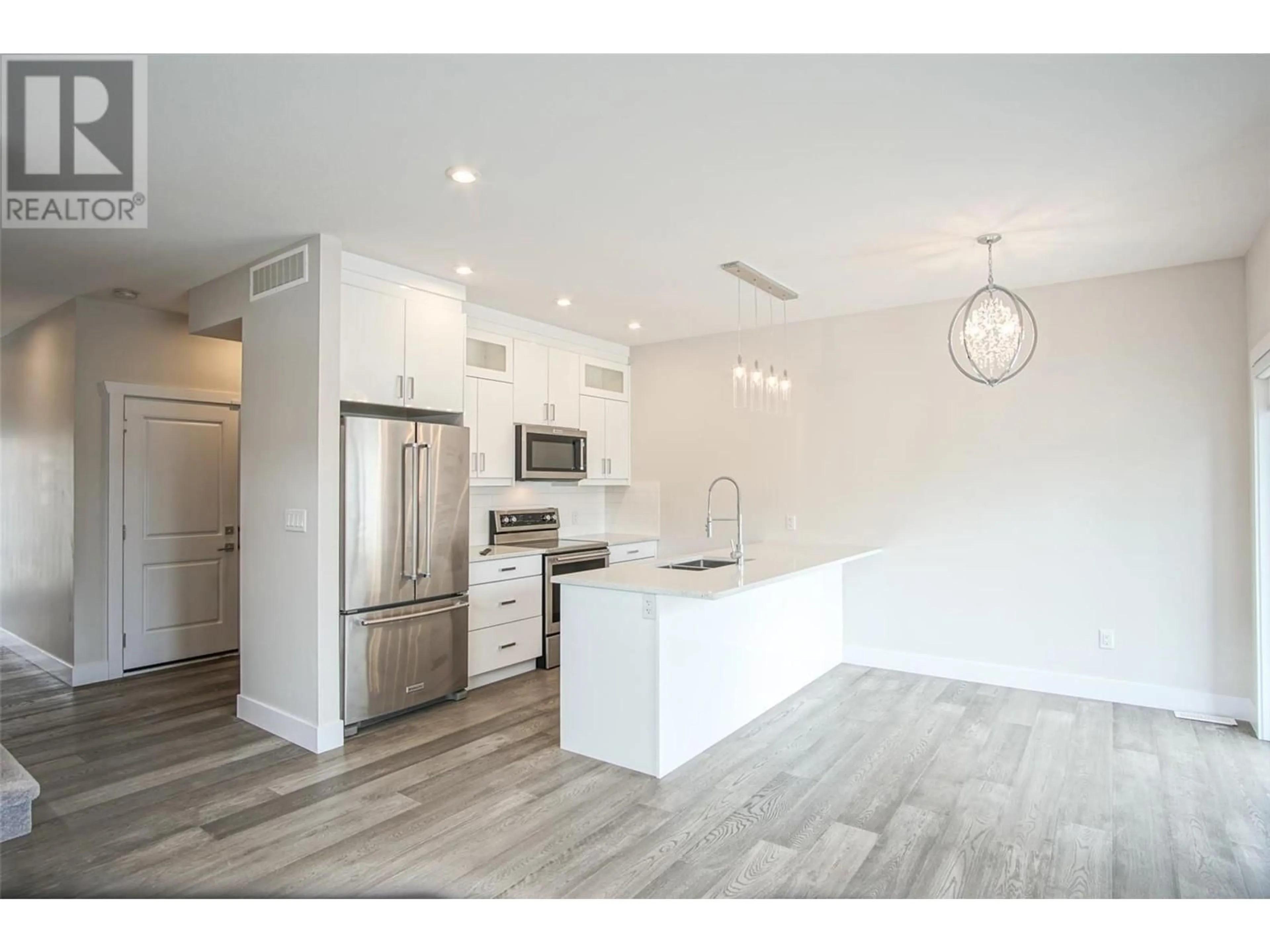 Open concept kitchen, wood/laminate floor for 1 - 415 RUTLAND ROAD, Kelowna British Columbia V1X3B3