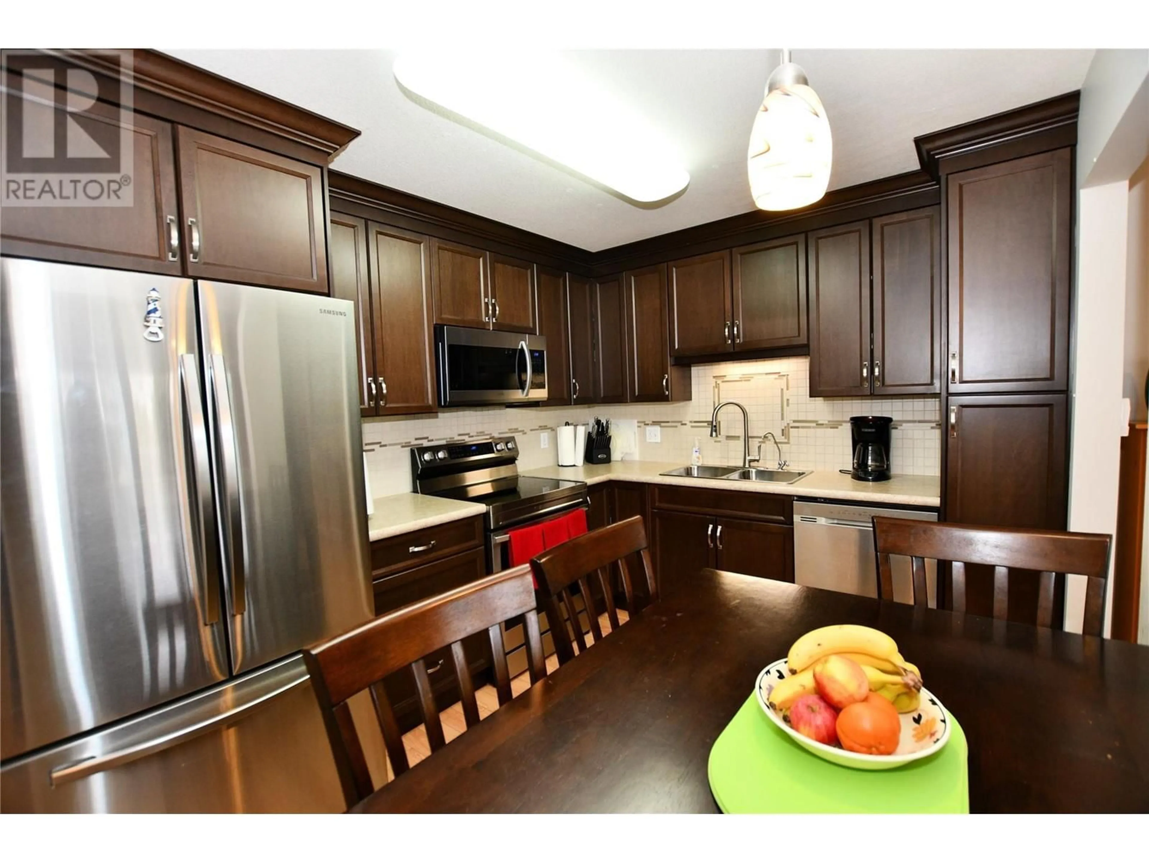Open concept kitchen, wood/laminate floor for 212 - 130 ABBOTT STREET, Penticton British Columbia V2A8P3