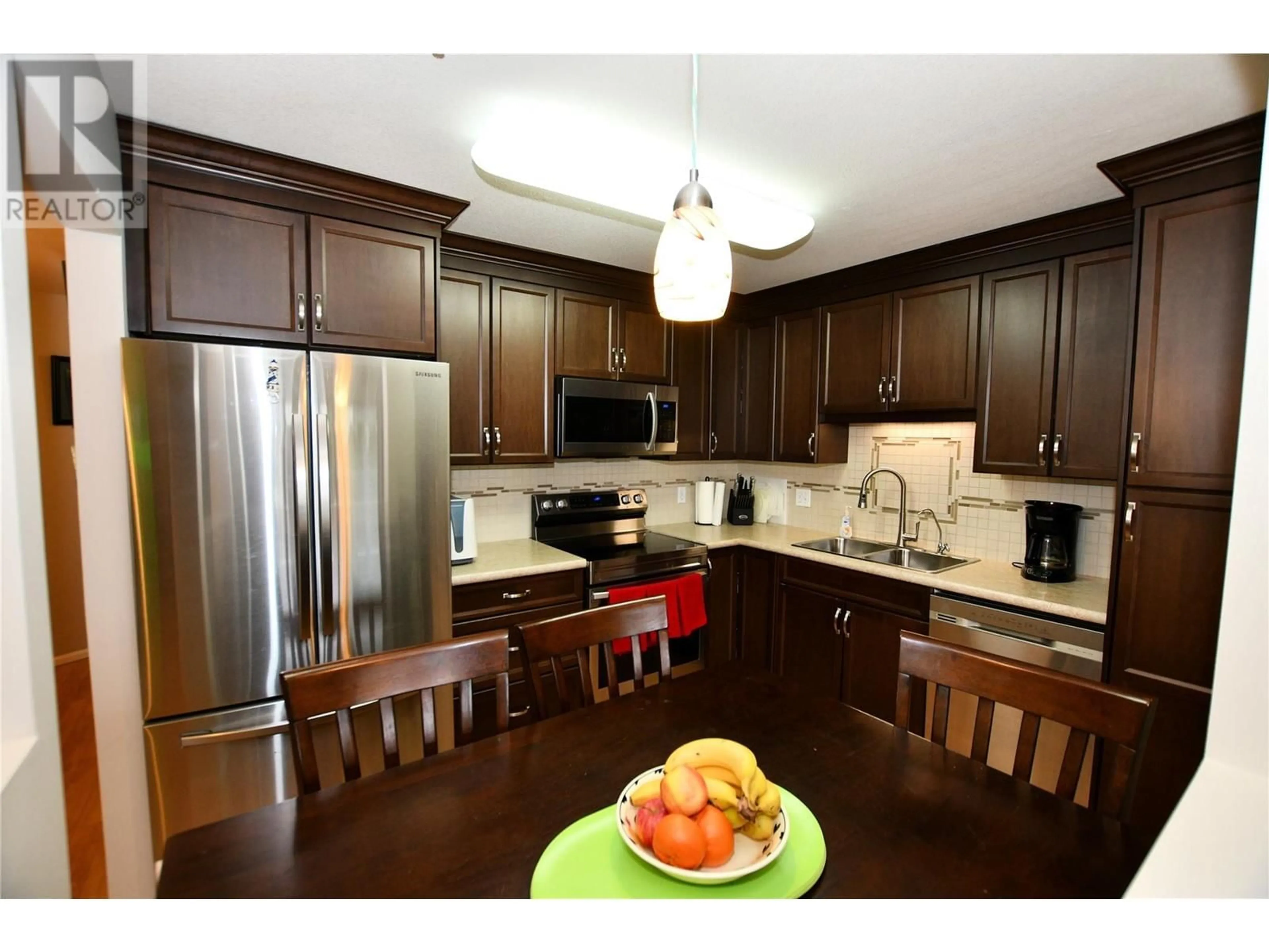 Open concept kitchen, wood/laminate floor for 212 - 130 ABBOTT STREET, Penticton British Columbia V2A8P3