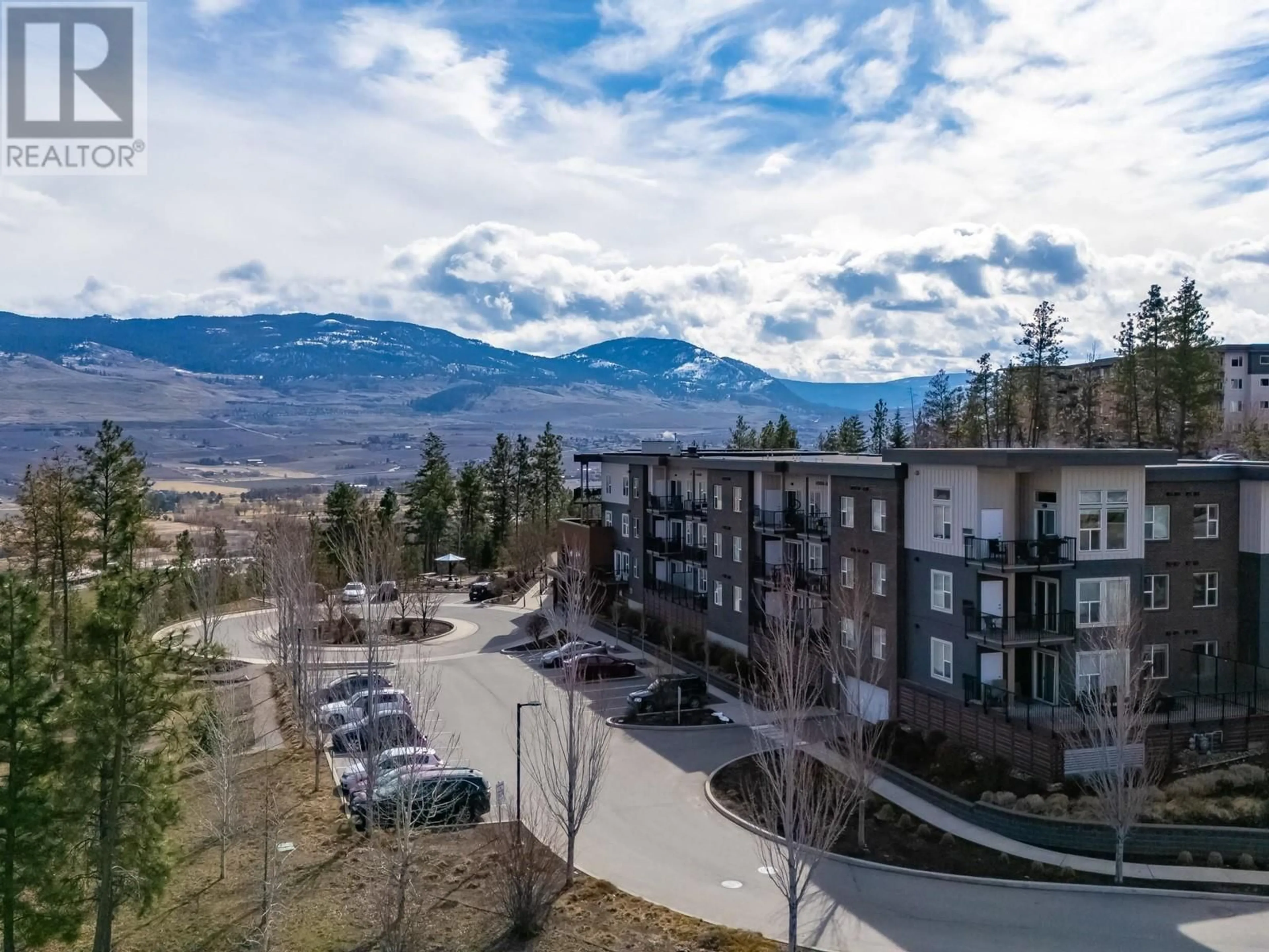 A pic from outside/outdoor area/front of a property/back of a property/a pic from drone, mountain view for 306 - 935 ACADEMY WAY, Kelowna British Columbia V1V3A4