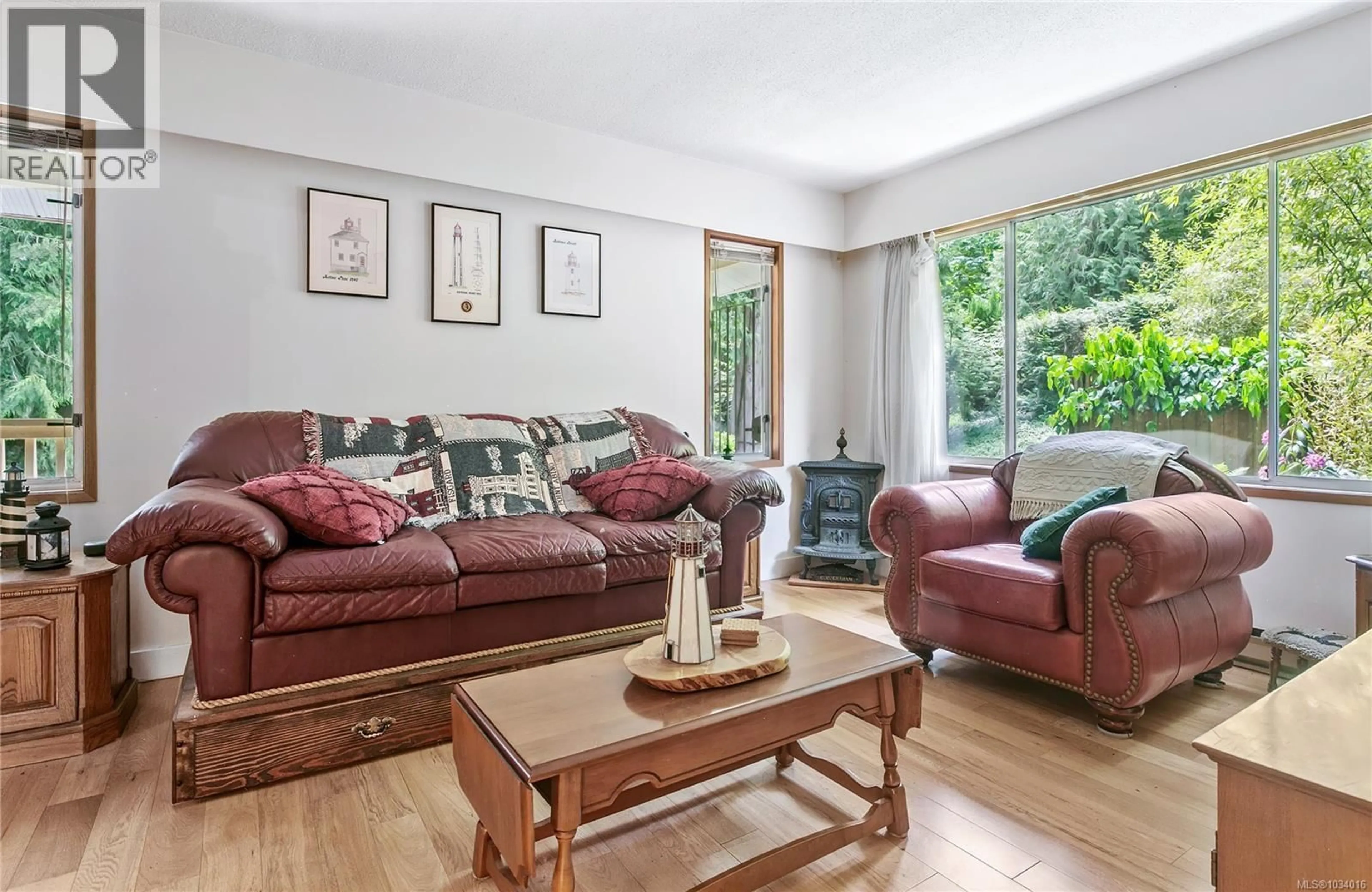 Living room with furniture, wood/laminate floor for 1970 LANDS END ROAD, North Saanich British Columbia V8L5J2