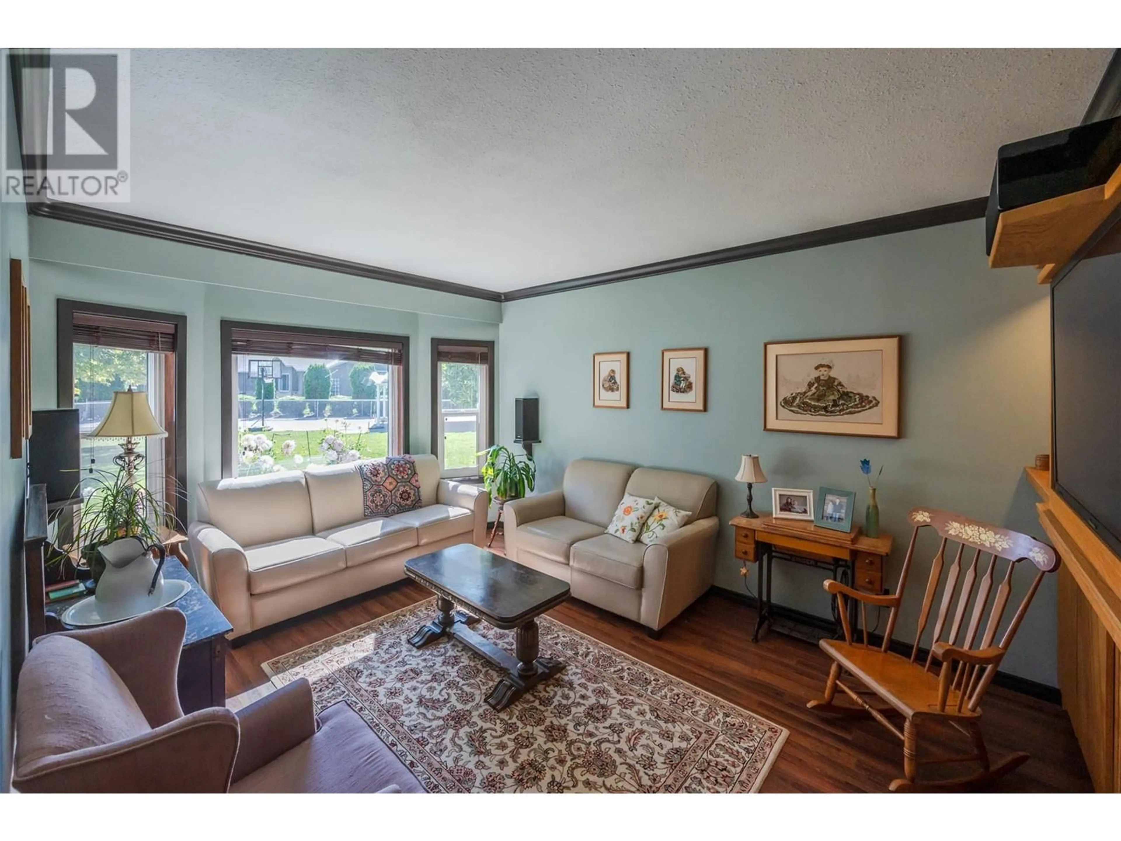 Living room with furniture, wood/laminate floor for 10112 BEAVIS PLACE, Summerland British Columbia V0H1Z2