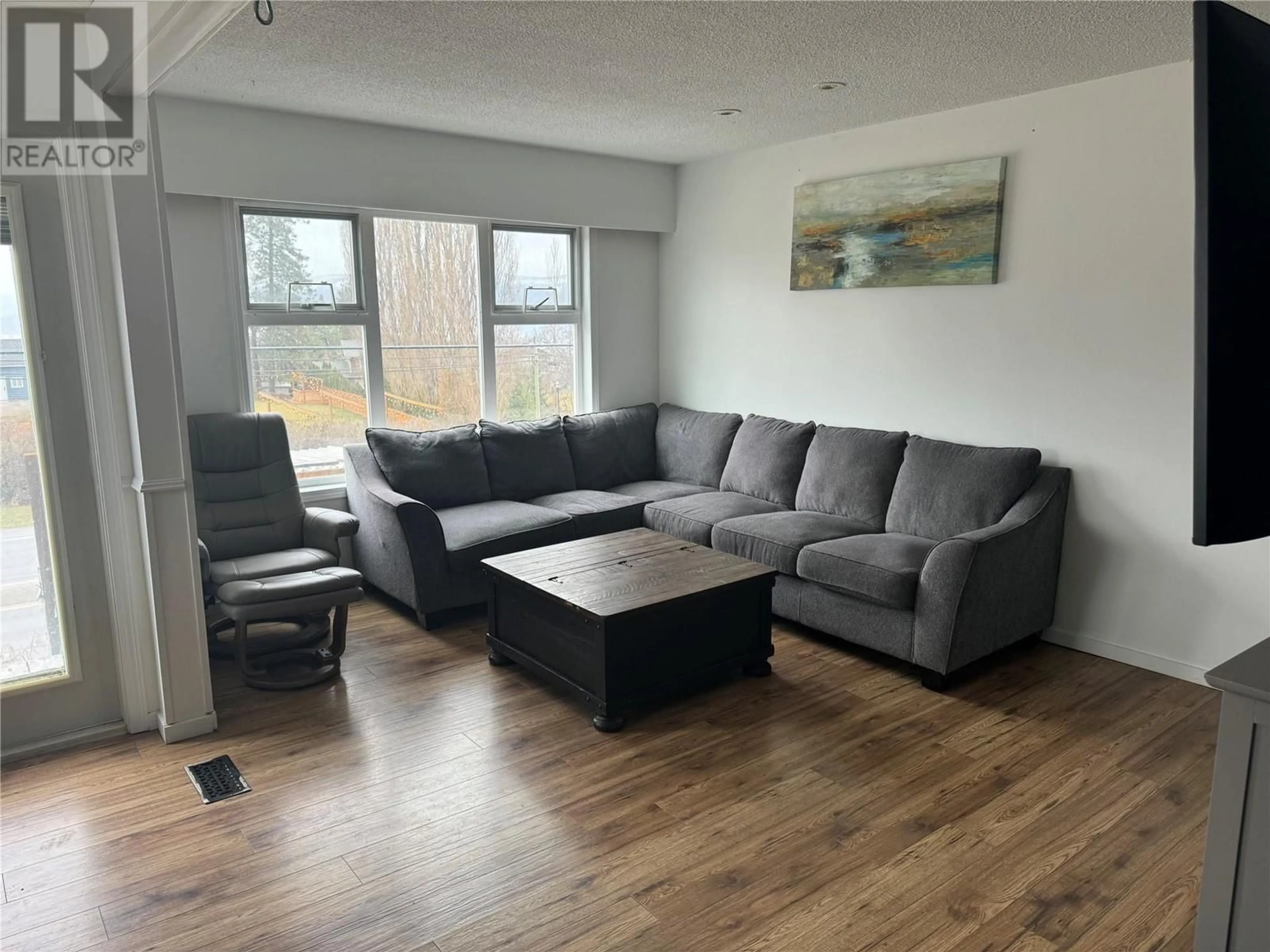 Living room with furniture, wood/laminate floor for 1350 BENTIEN ROAD, Kelowna British Columbia V1X7K3