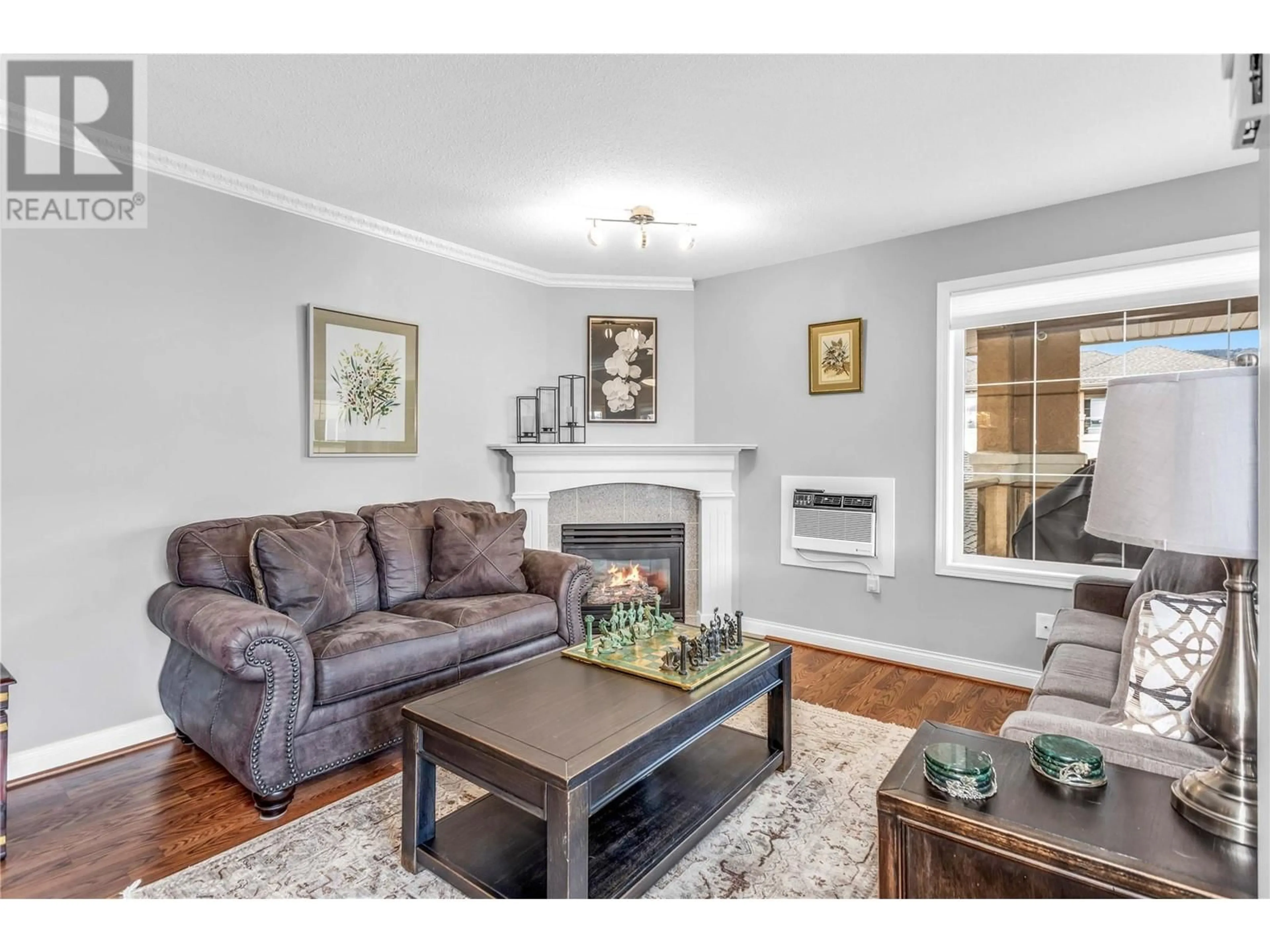 Living room with furniture, wood/laminate floor for 304 - 3870 BROWN ROAD, West Kelowna British Columbia V4T2J5