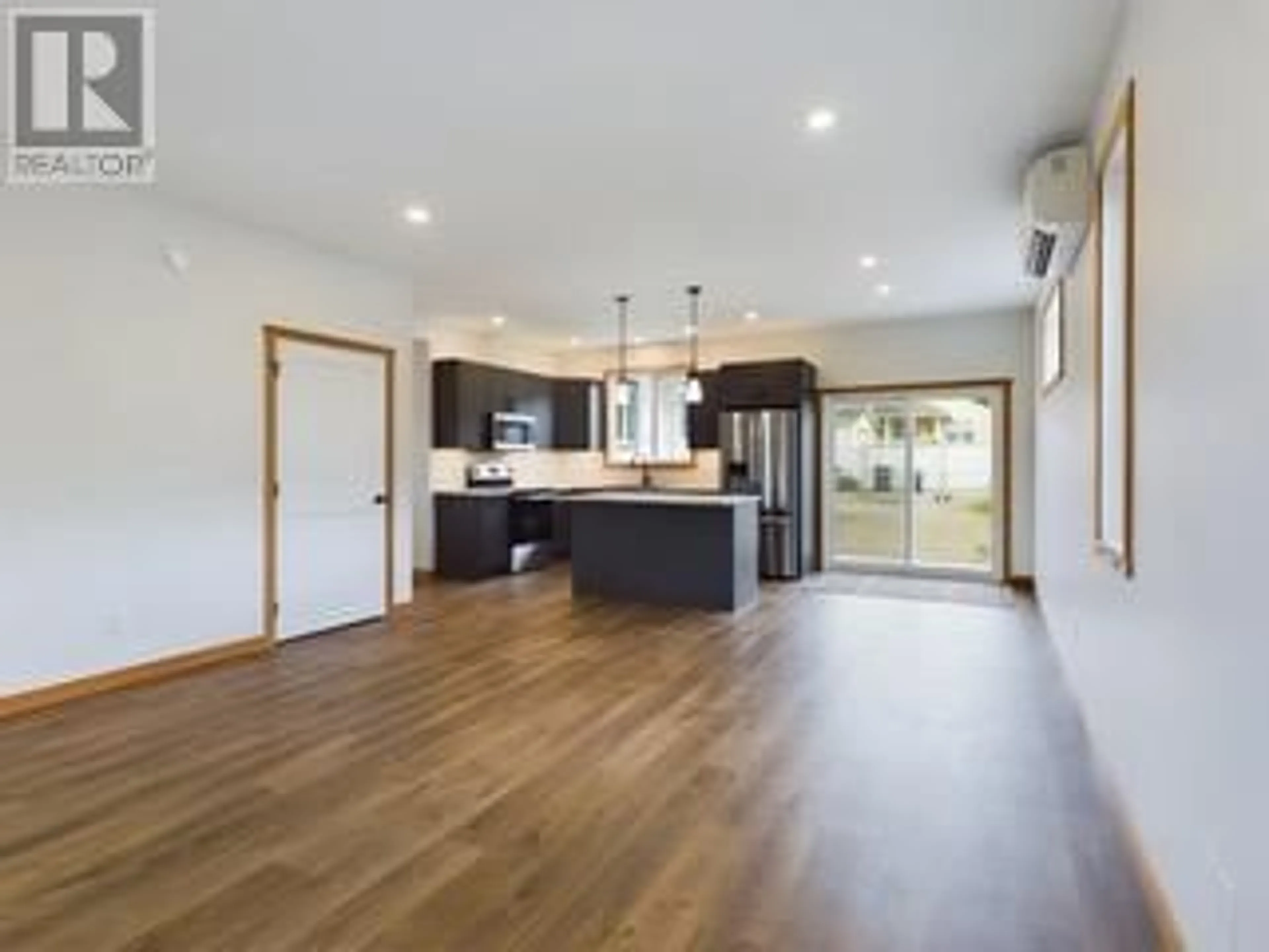 Open concept kitchen, wood/laminate floor for 555 EARLE CRESCENT, Oliver British Columbia V0H1T0