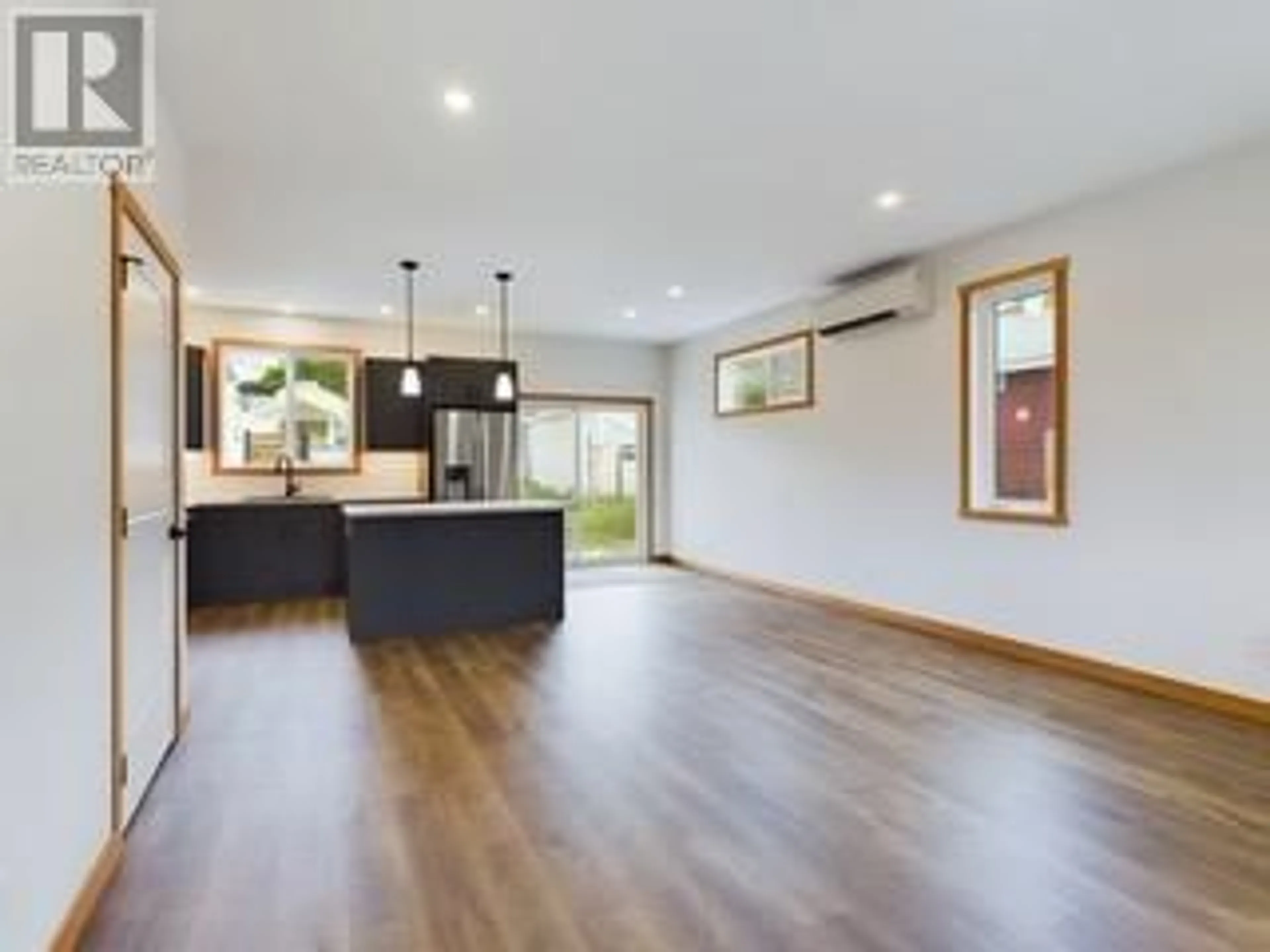 Open concept kitchen, wood/laminate floor for 555 EARLE CRESCENT, Oliver British Columbia V0H1T0