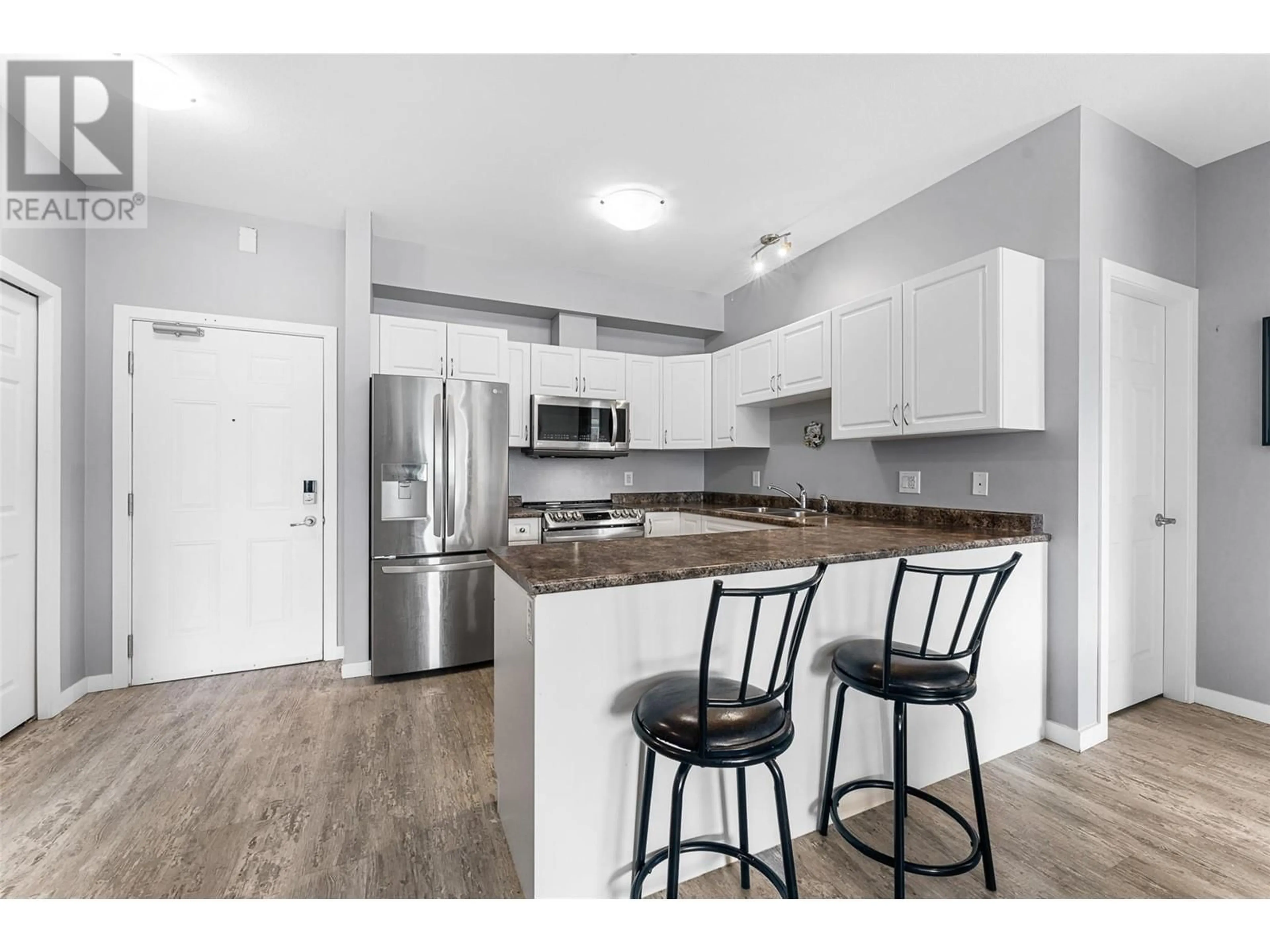 Open concept kitchen, wood/laminate floor for 770 Rutland Road N Unit# 306, Kelowna British Columbia V1X7B7