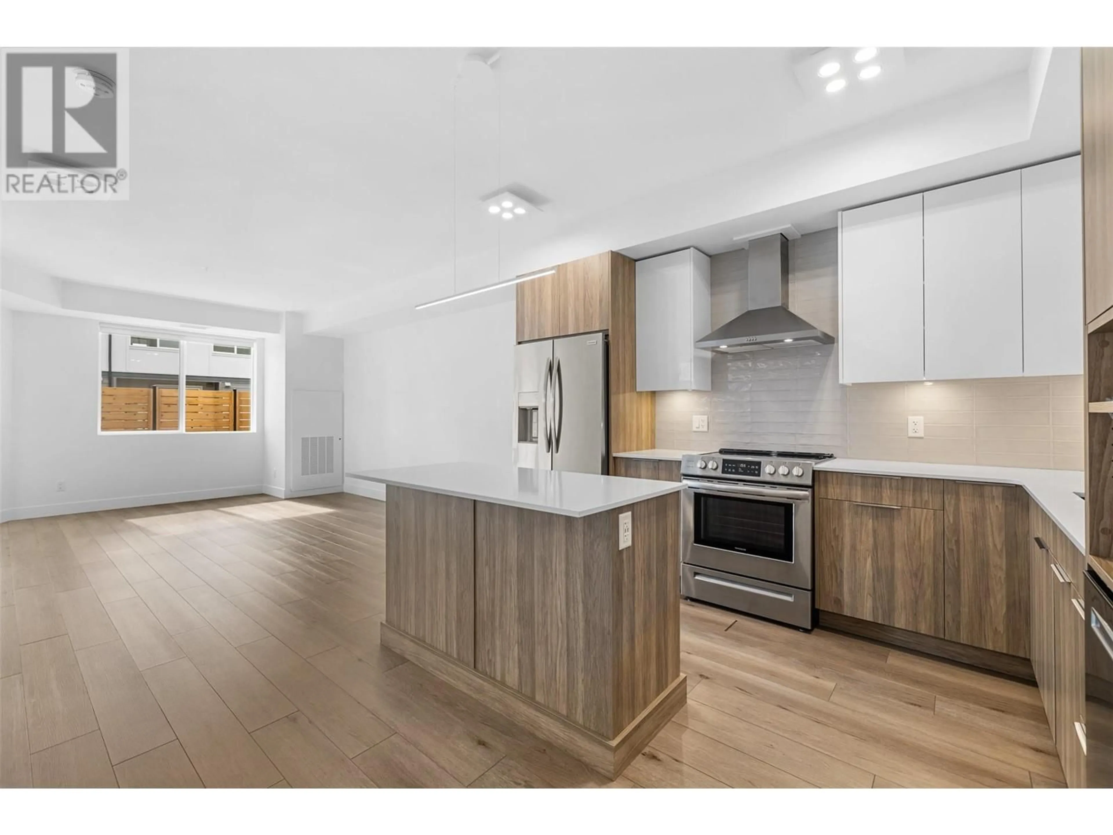 Open concept kitchen, wood/laminate floor for 202 - 3634 MISSION SPRINGS DRIVE, Kelowna British Columbia V1W0C9