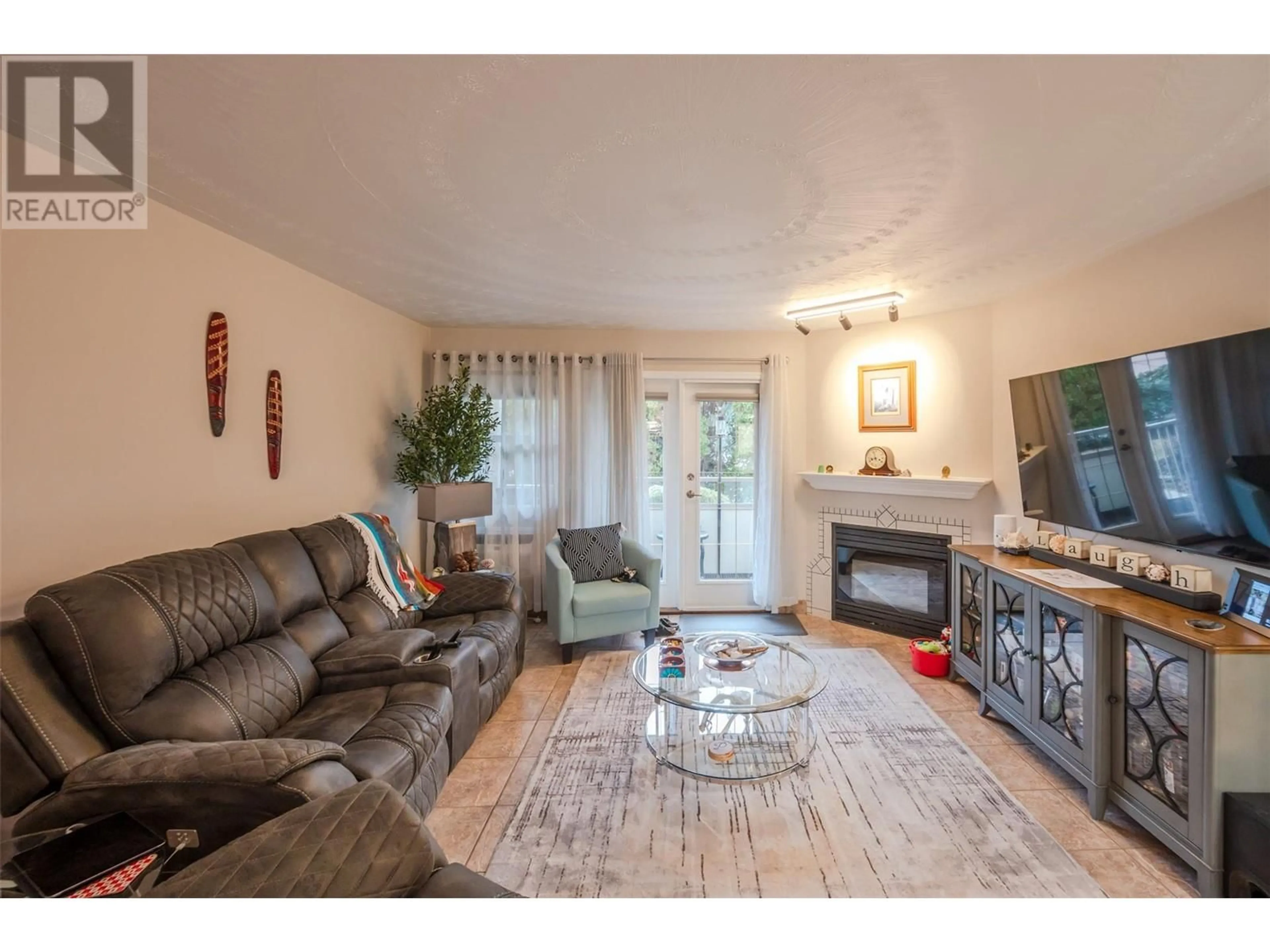 Living room with furniture, wood/laminate floor for 103 - 8408 JUBILEE ROAD, Summerland British Columbia V0H1Z5