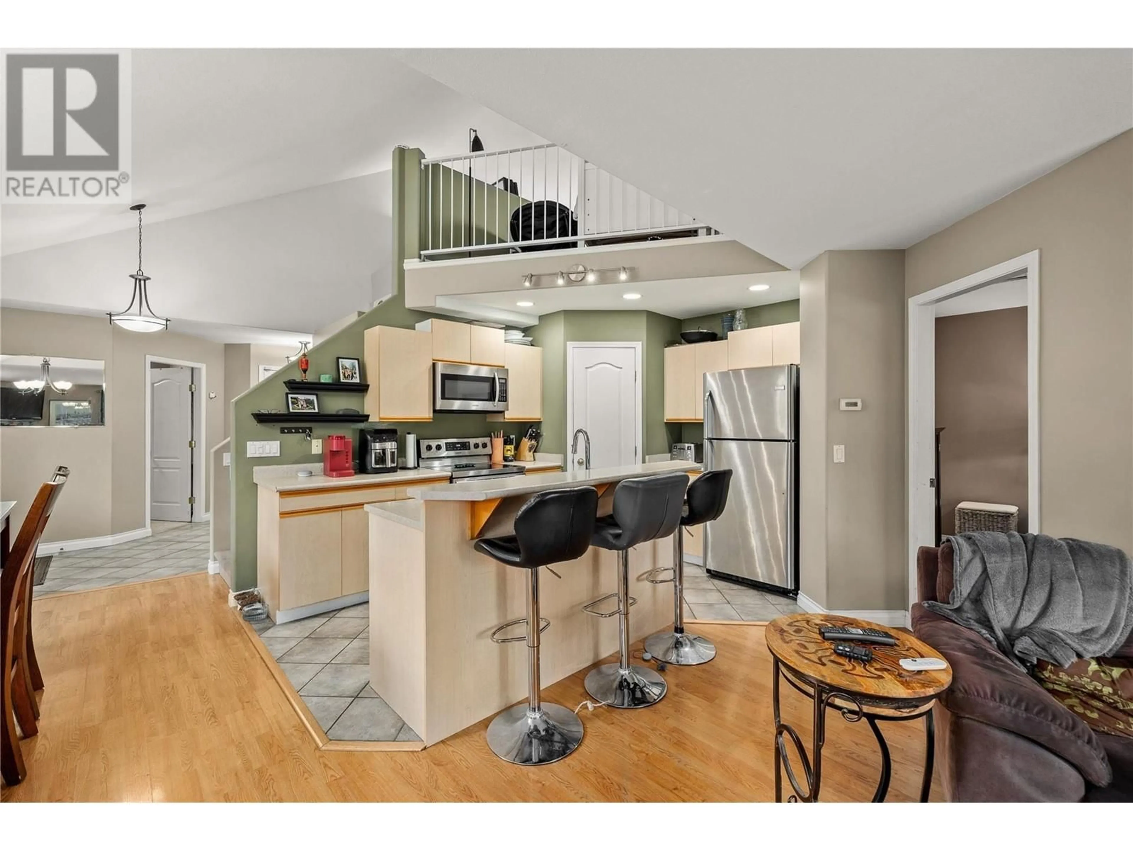 Open concept kitchen, wood/laminate floor for 100 VERNA COURT, Kelowna British Columbia V4T2G3